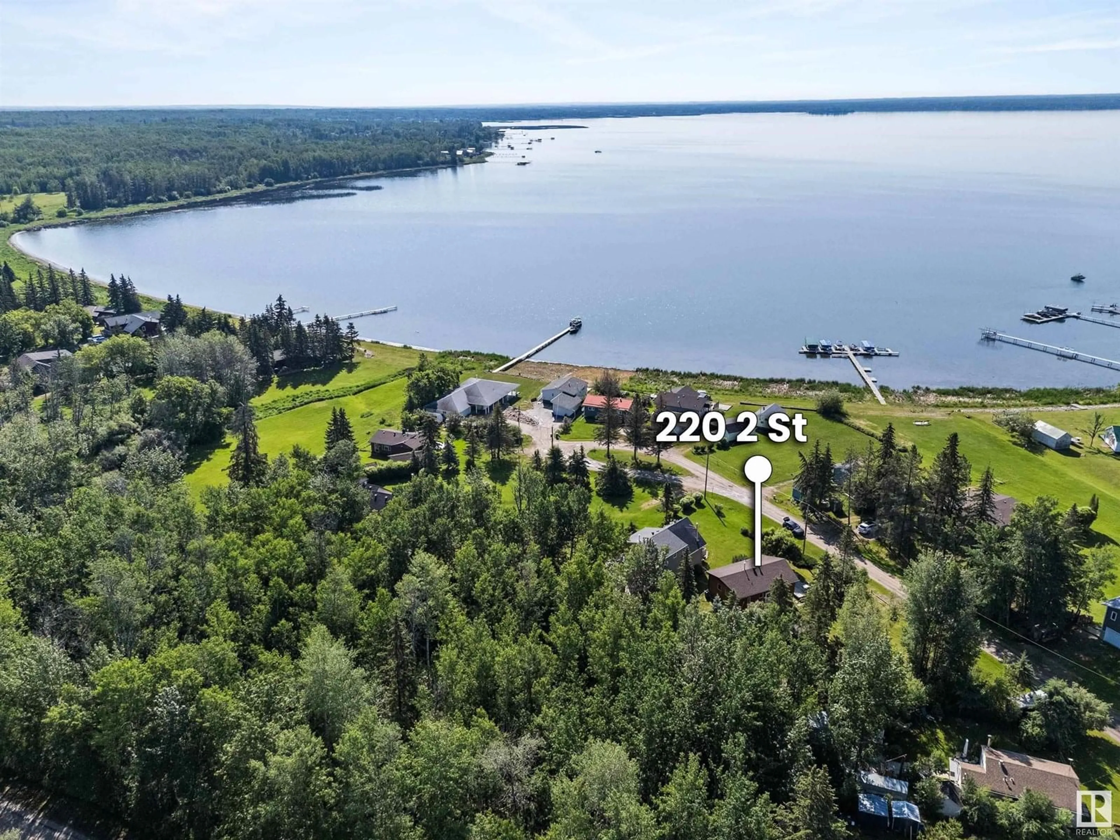 A pic from outside/outdoor area/front of a property/back of a property/a pic from drone, water/lake/river/ocean view for 220 2 ST, Rural Lac Ste. Anne County Alberta T0E1A0