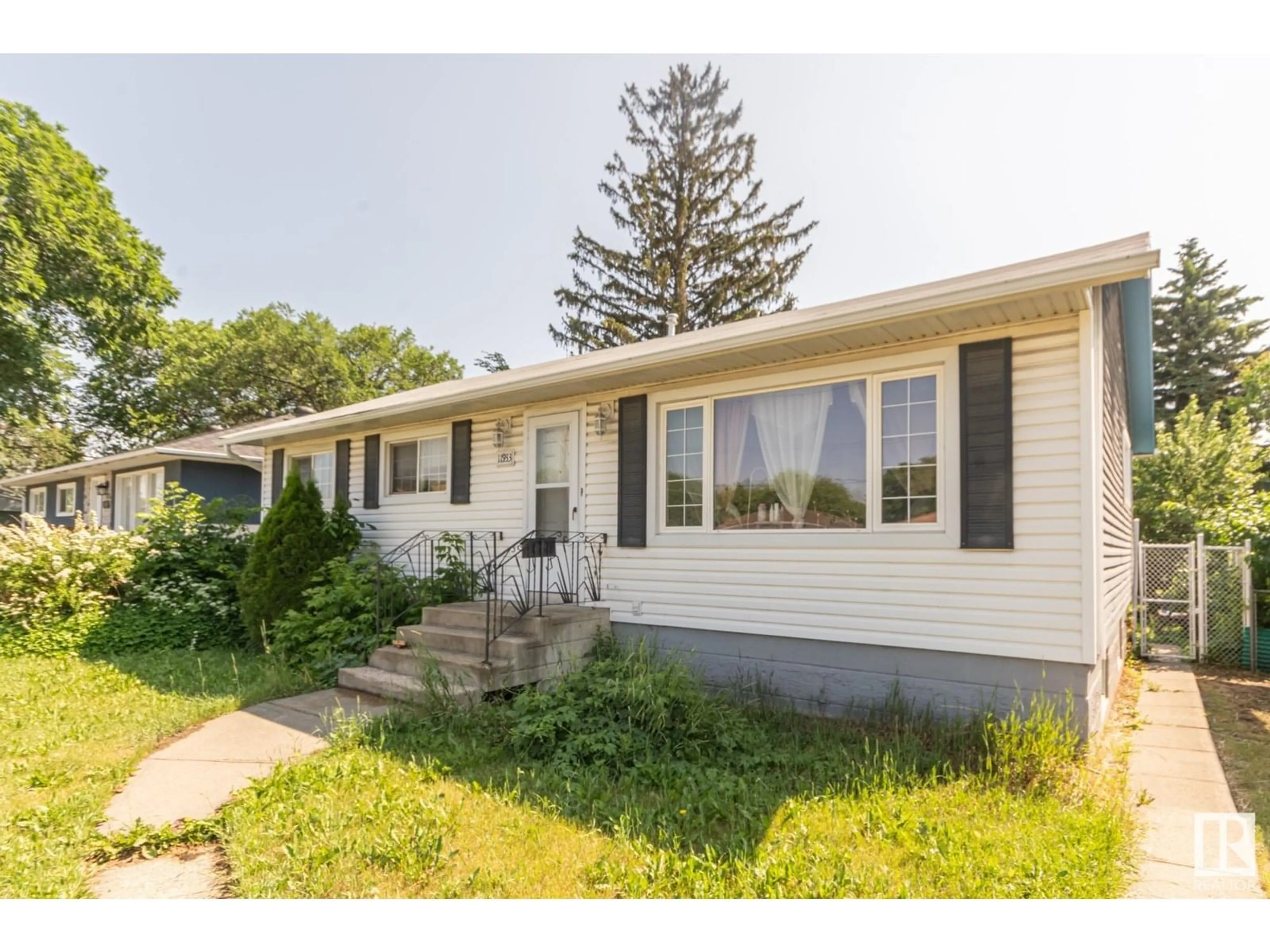 Home with vinyl exterior material, street for NW - 11933 50 ST, Edmonton Alberta T5W3C1