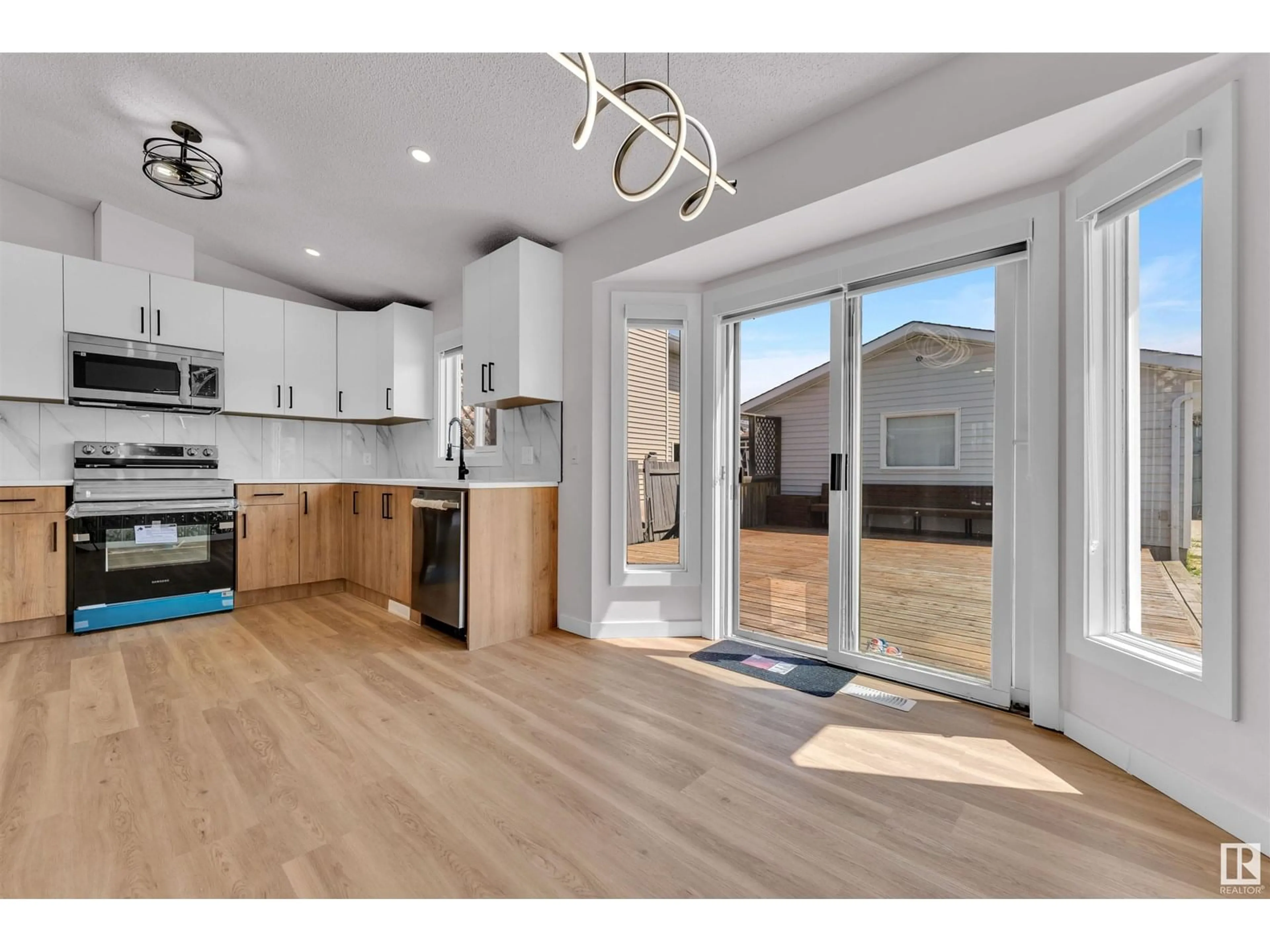 Open concept kitchen, wood/laminate floor for 4912 31 AV, Edmonton Alberta T6L5H6