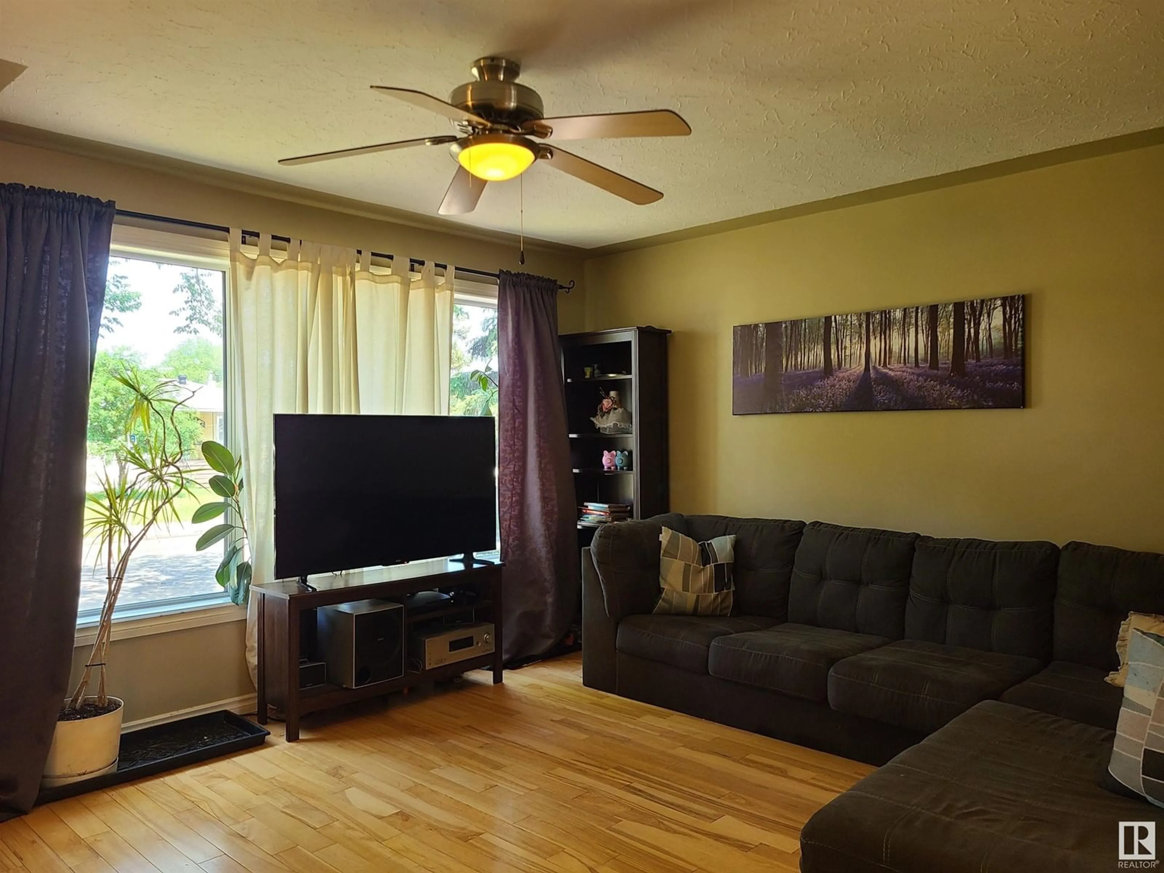 Living room with furniture, wood/laminate floor for 4805 114 AV, Edmonton Alberta T5W0T7