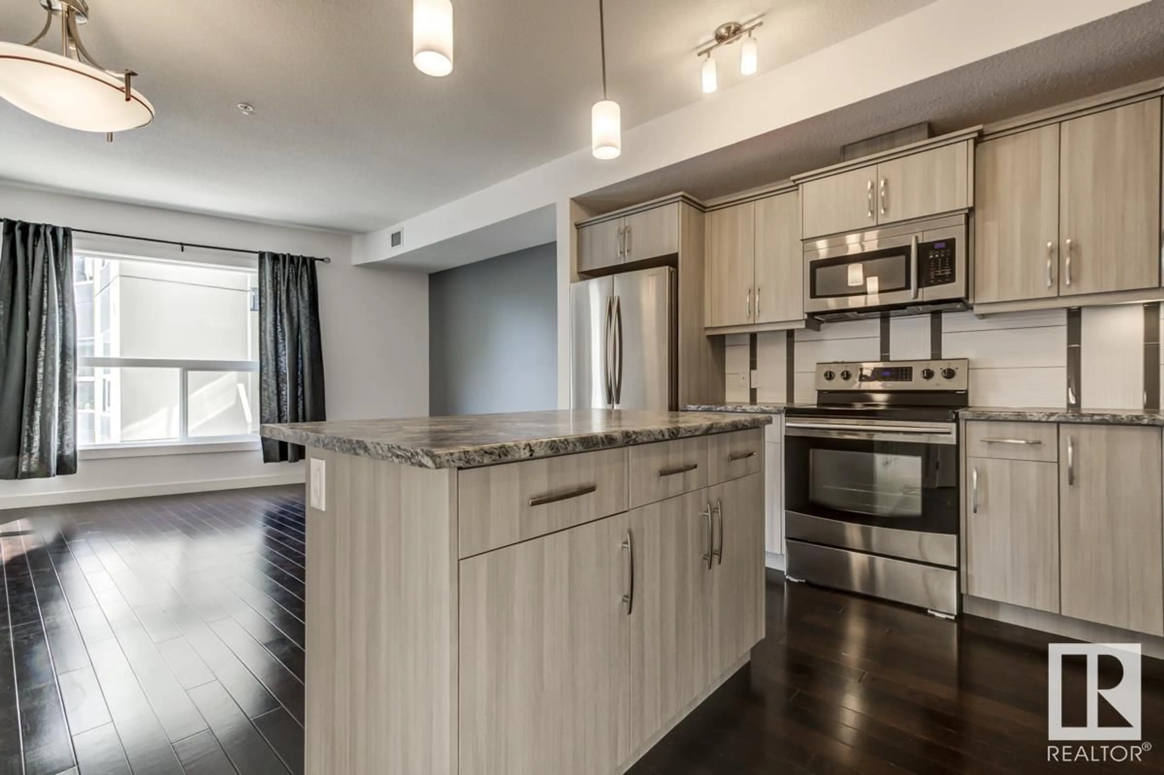 Open concept kitchen, wood/laminate floor for #219 - 10523 123 ST, Edmonton Alberta T5N1W9