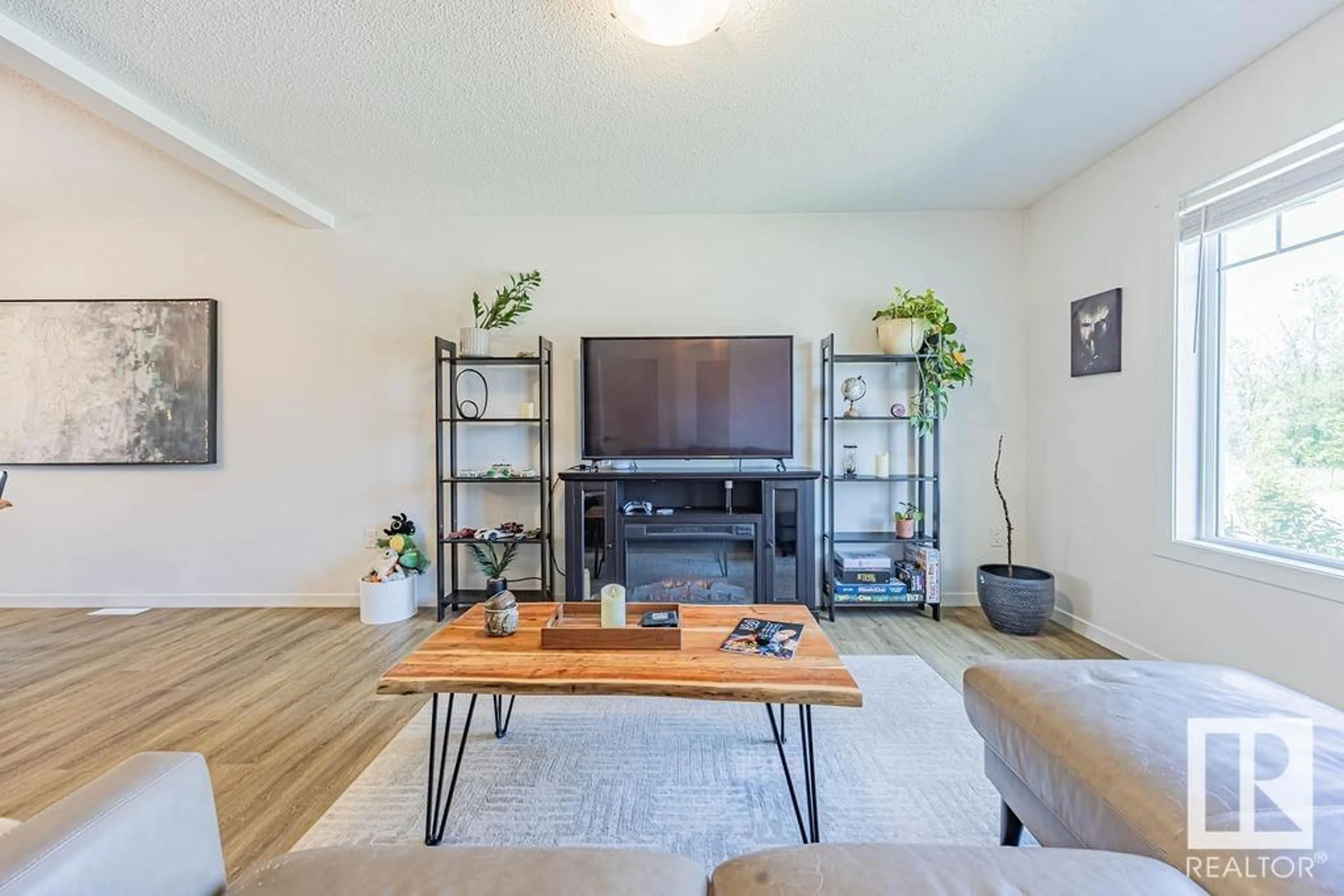 Living room with furniture, wood/laminate floor for 1177 CY BECKER RD, Edmonton Alberta T5Y3W1