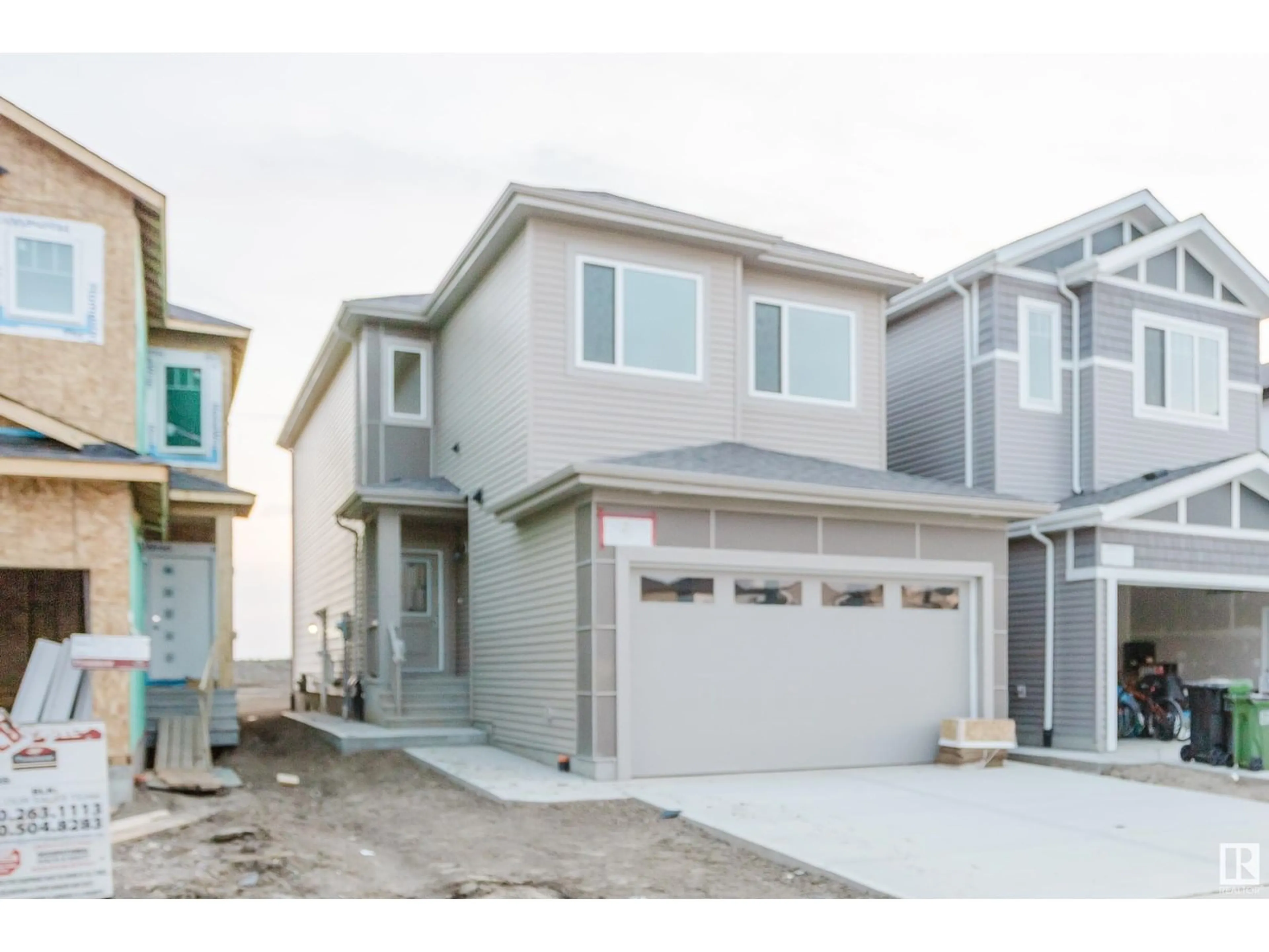 Home with vinyl exterior material, street for NW - 2036 210 ST, Edmonton Alberta T6M3H6