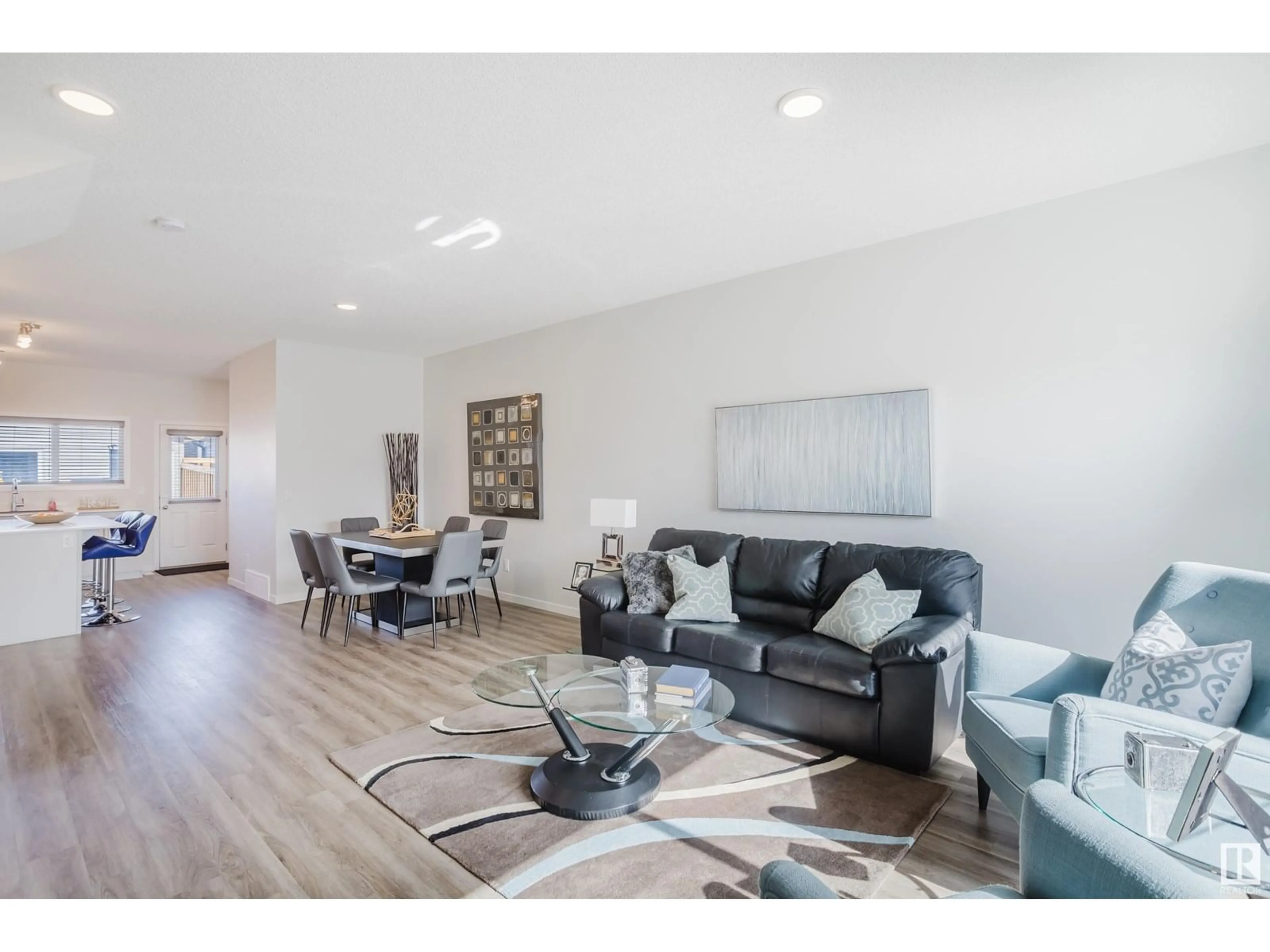 Living room with furniture, wood/laminate floor for 5210 LARK CR, Edmonton Alberta T5S0S3