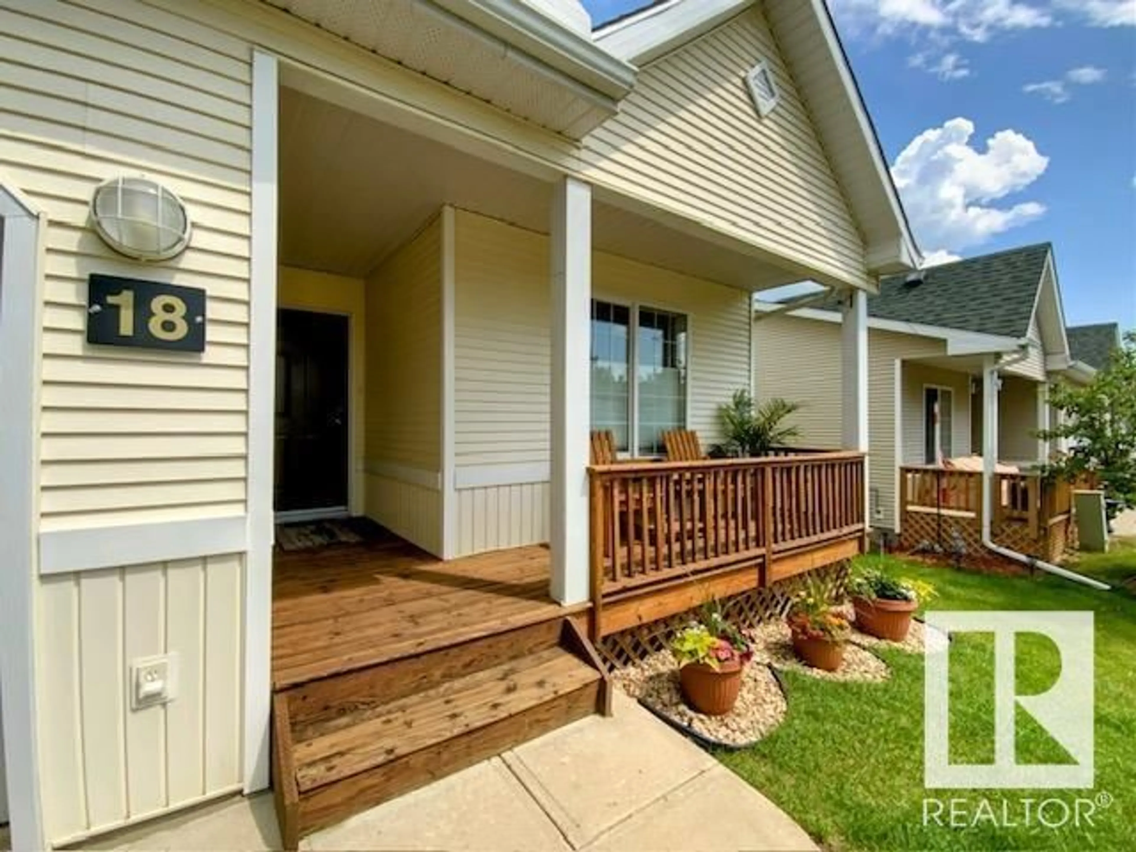 Home with vinyl exterior material, street for 18 VILLAGE LN, Rural Wetaskiwin County Alberta T0C2V0