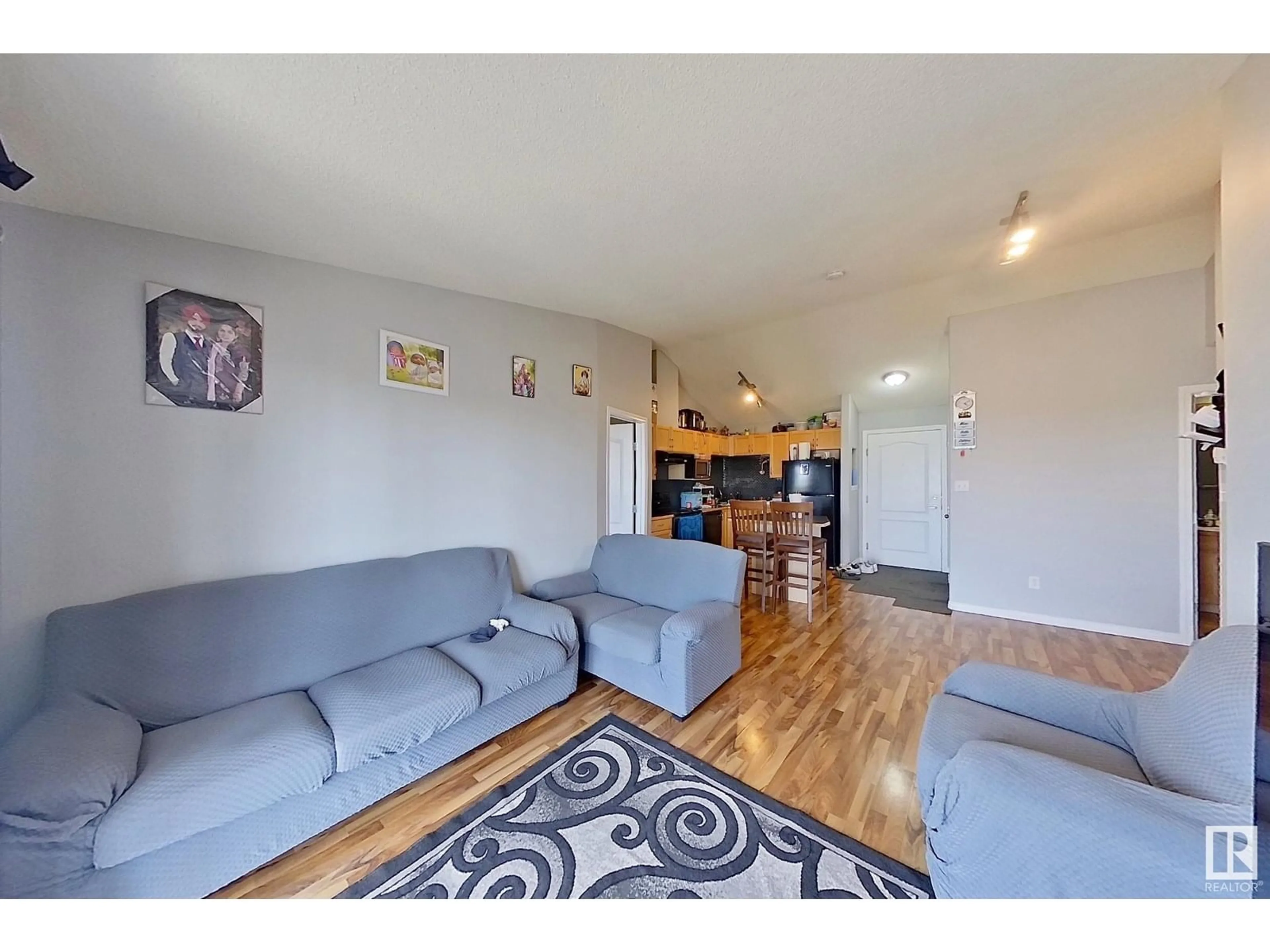 Living room with furniture, wood/laminate floor for 418 - 3425 19 ST NW, Edmonton Alberta T6T2B5