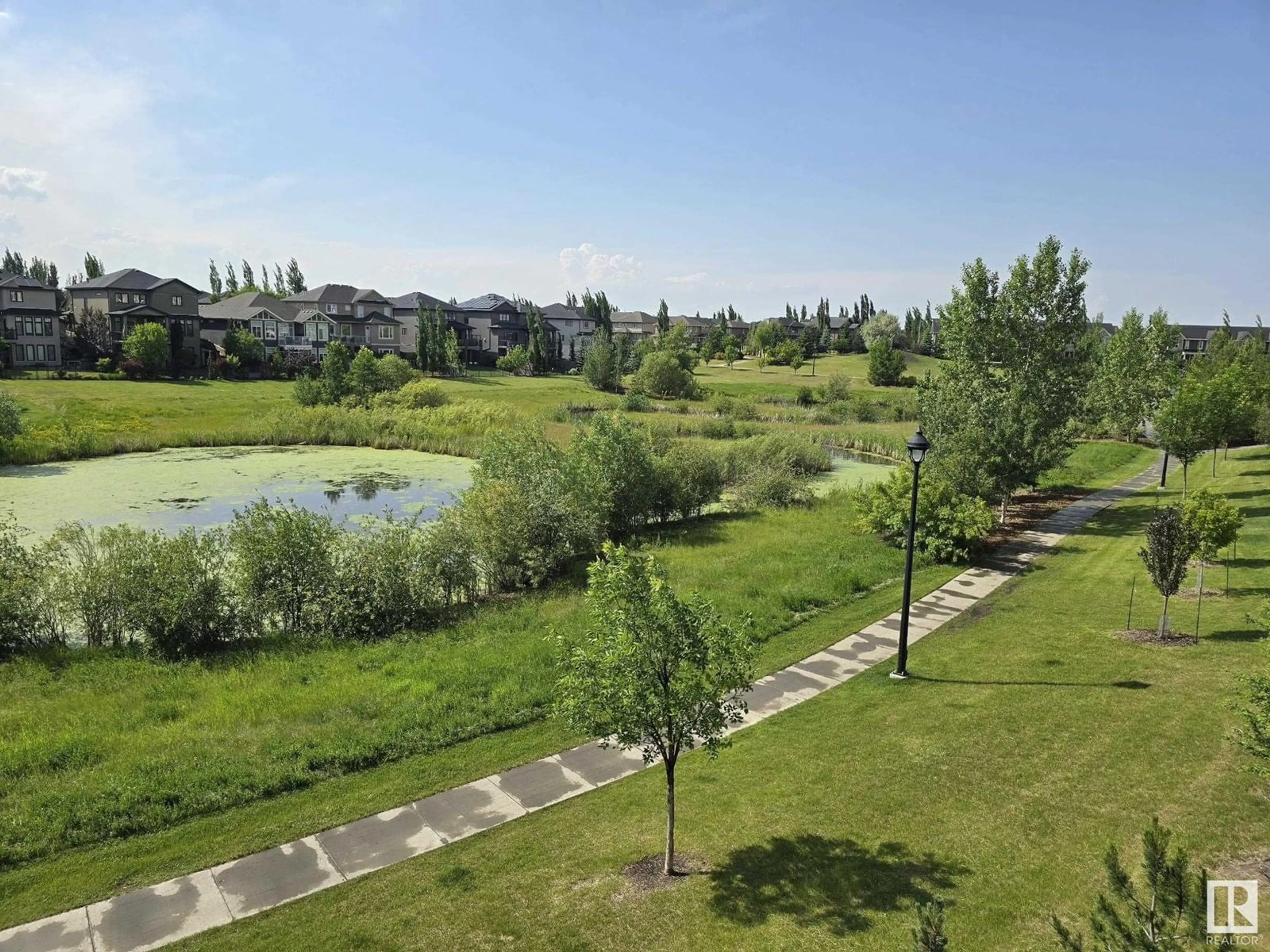 A pic from outside/outdoor area/front of a property/back of a property/a pic from drone, water/lake/river/ocean view for #206 - 1316 WINDERMERE WY, Edmonton Alberta T6W0P1