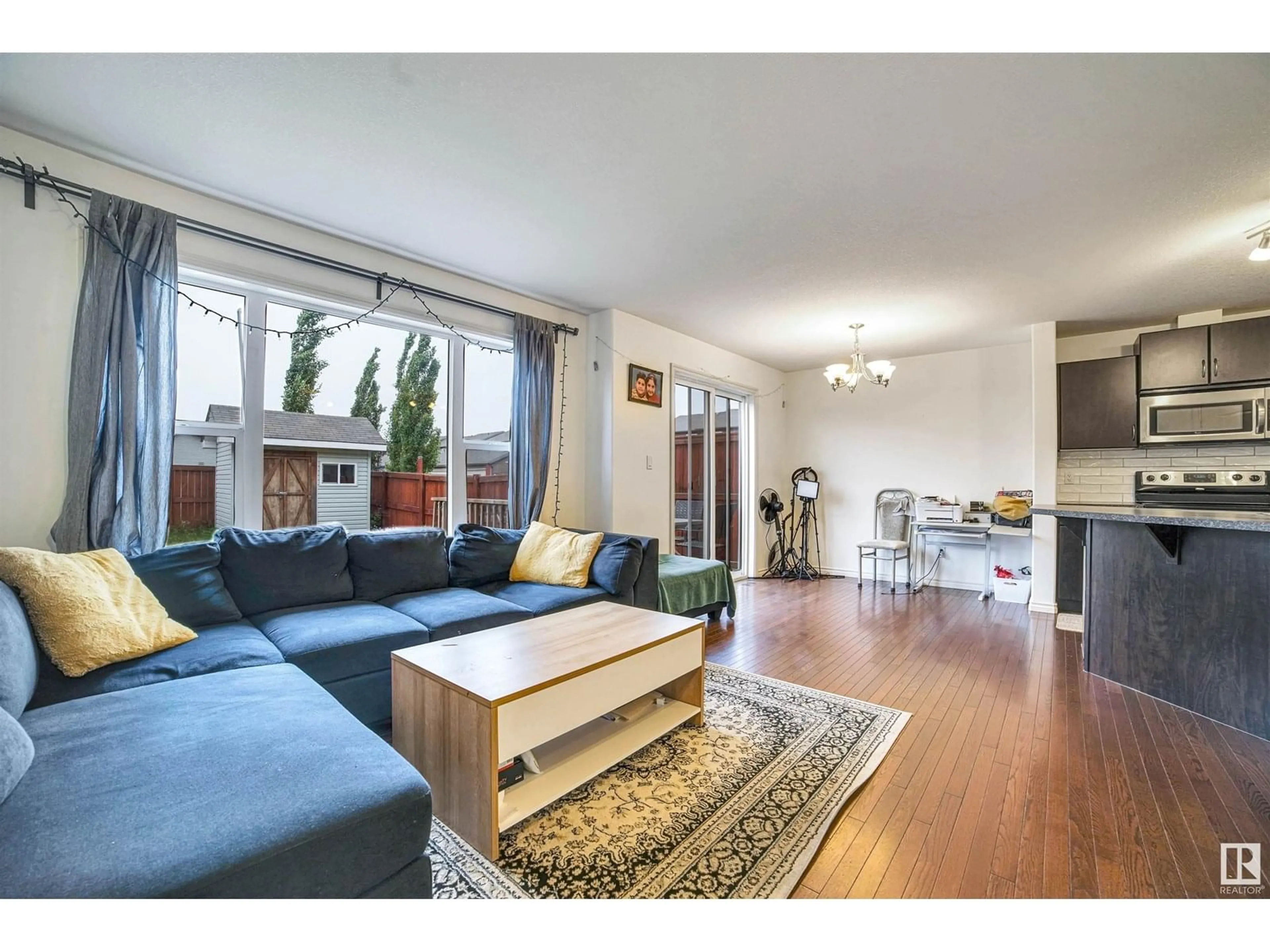 Living room with furniture, wood/laminate floor for 3019 22 AV, Edmonton Alberta T6T0J9