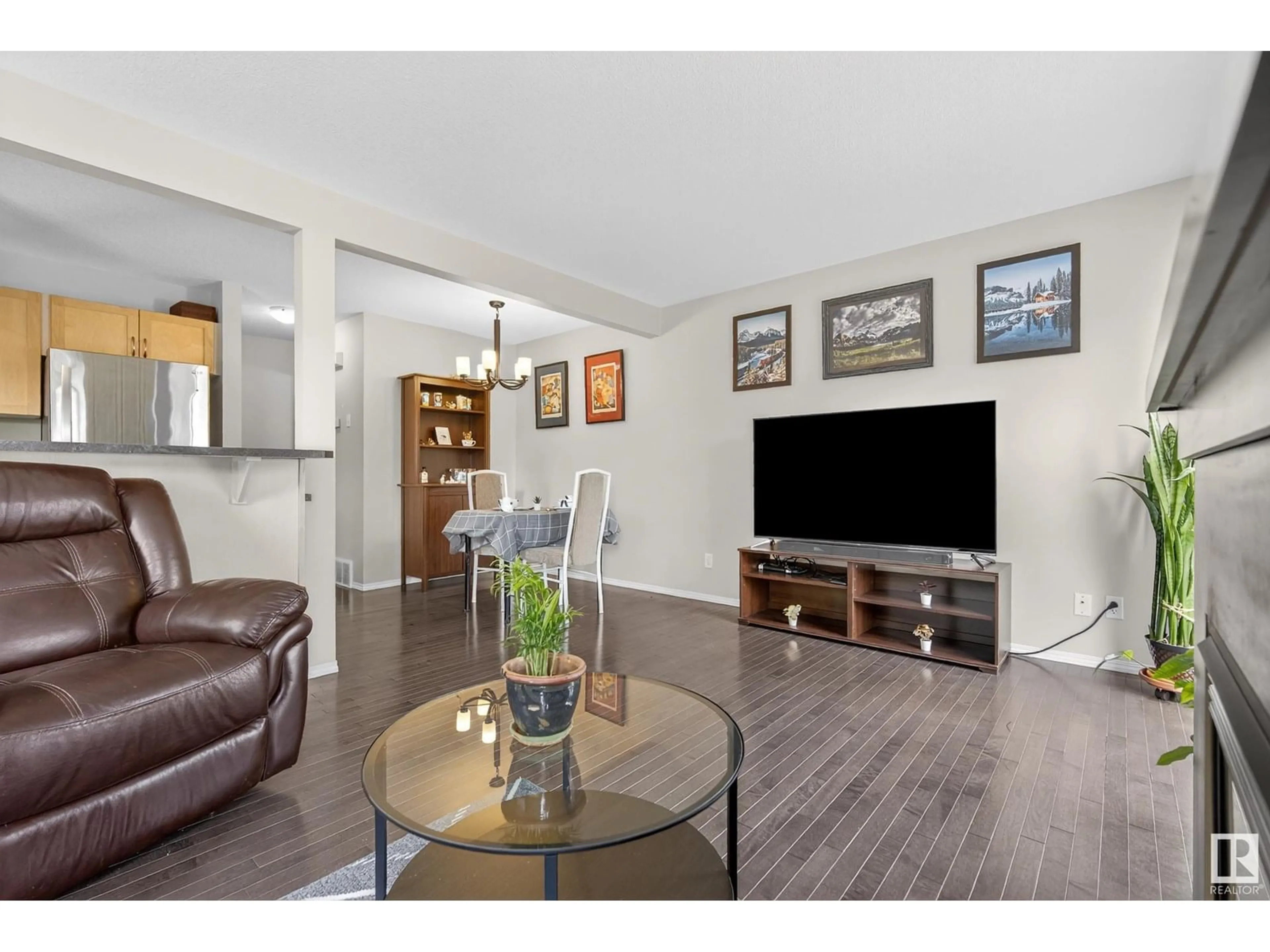 Living room with furniture, wood/laminate floor for #140 - 150 EDWARDS DR, Edmonton Alberta T6X1M4