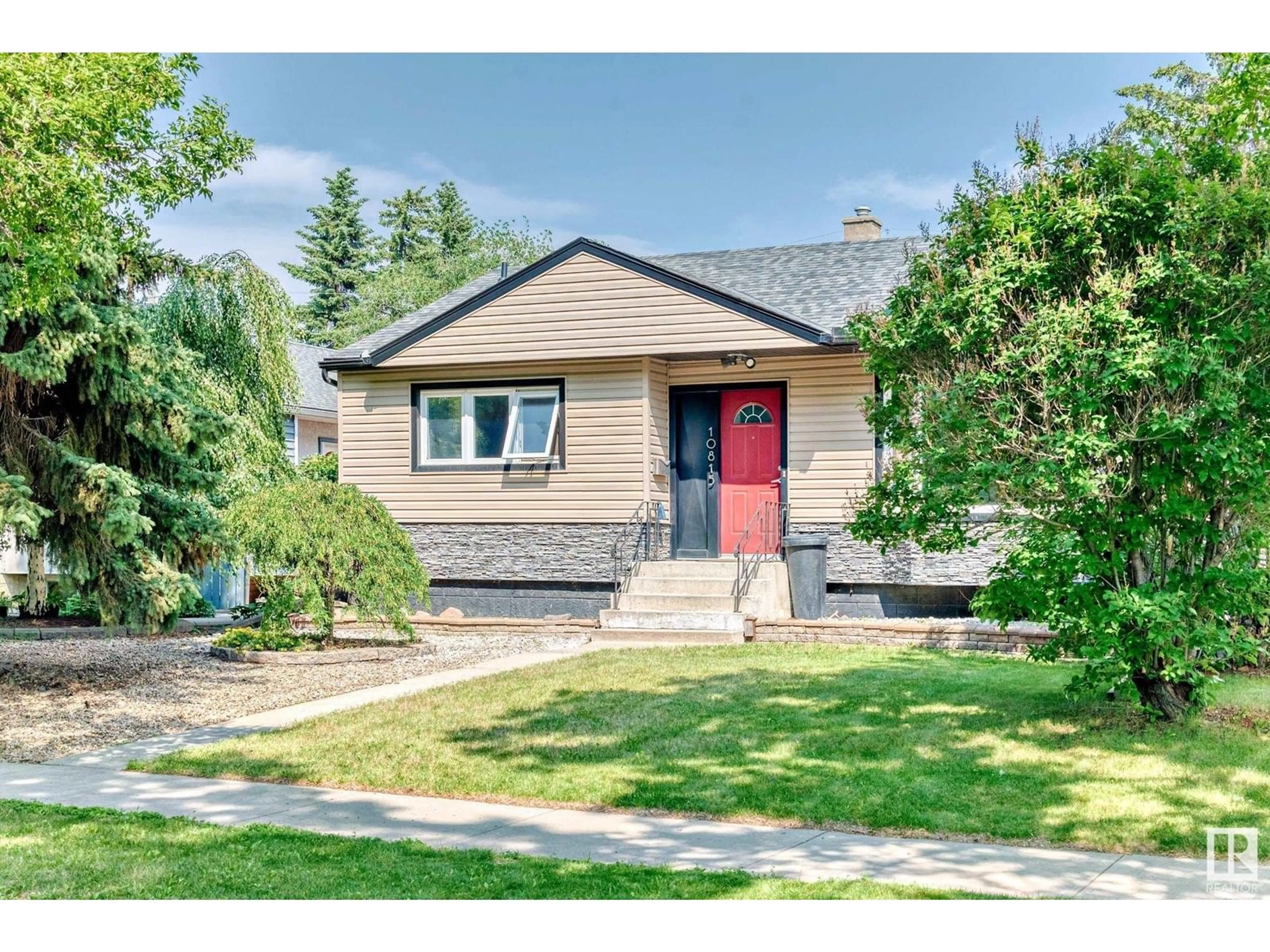 Home with vinyl exterior material, street for NW - 10815 147 ST, Edmonton Alberta T5N3E1
