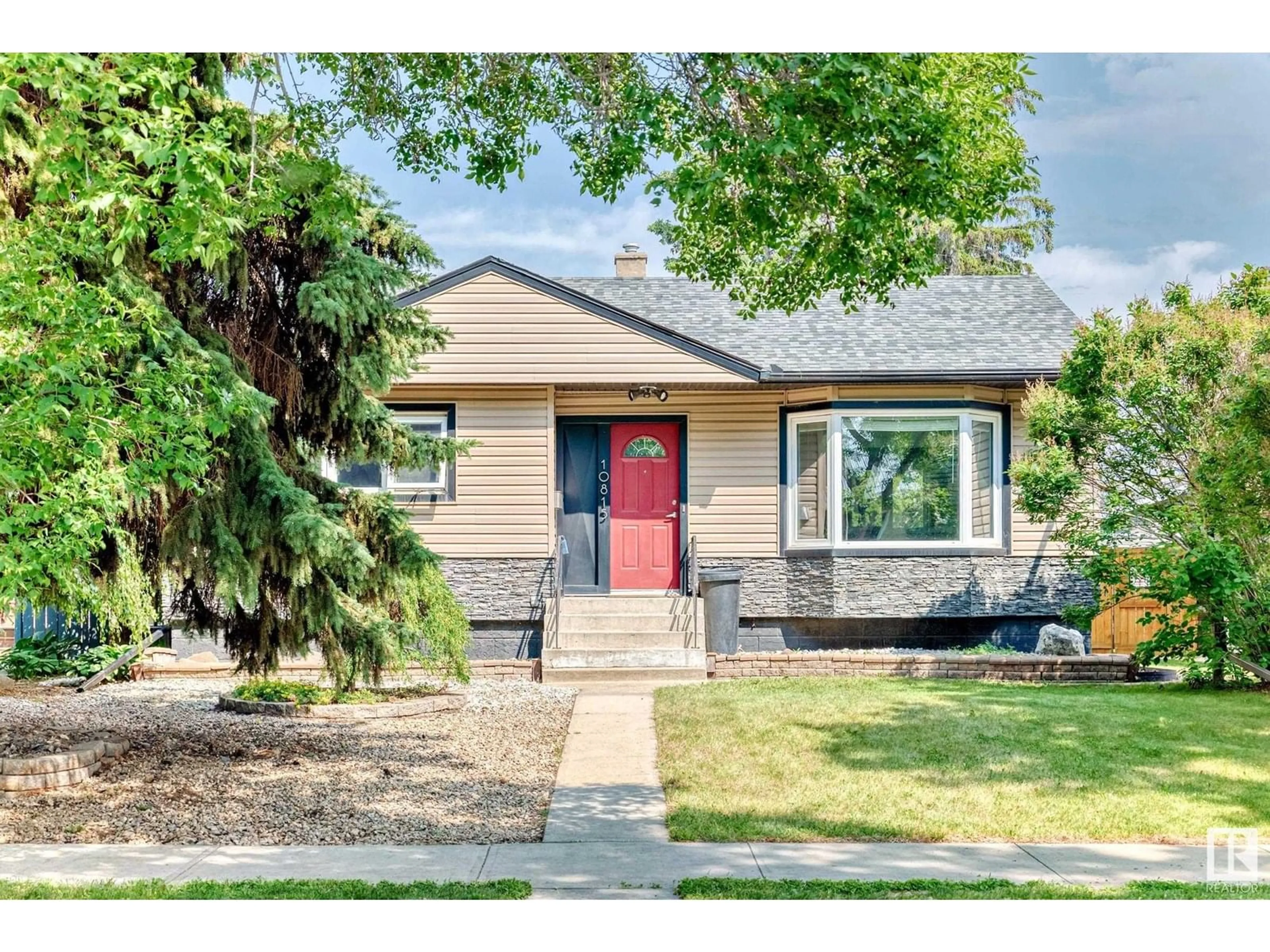 Home with vinyl exterior material, street for NW - 10815 147 ST, Edmonton Alberta T5N3E1