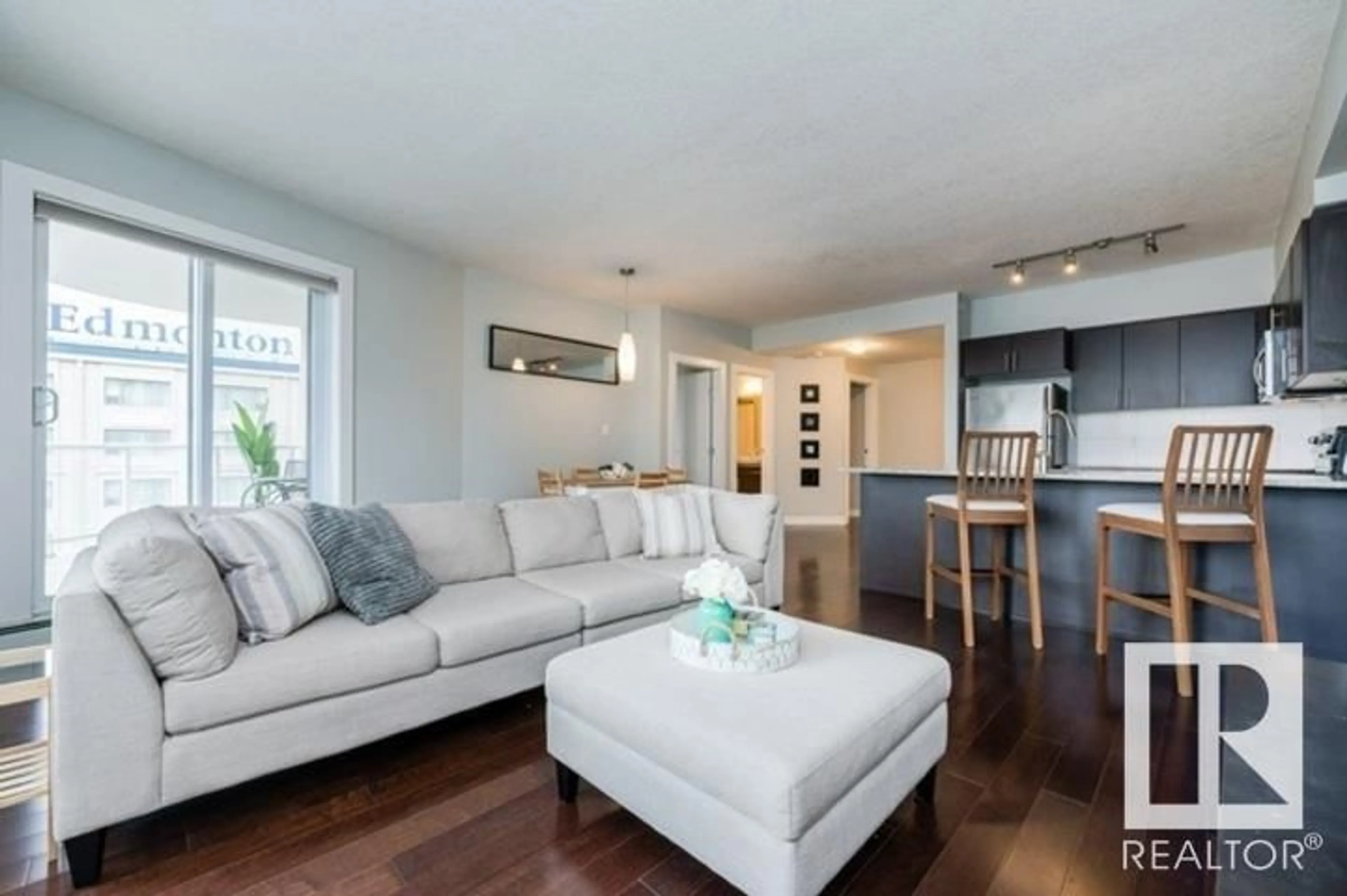 Living room with furniture, wood/laminate floor for 10152 - 1705 104 ST NW, Edmonton Alberta T5J0B6