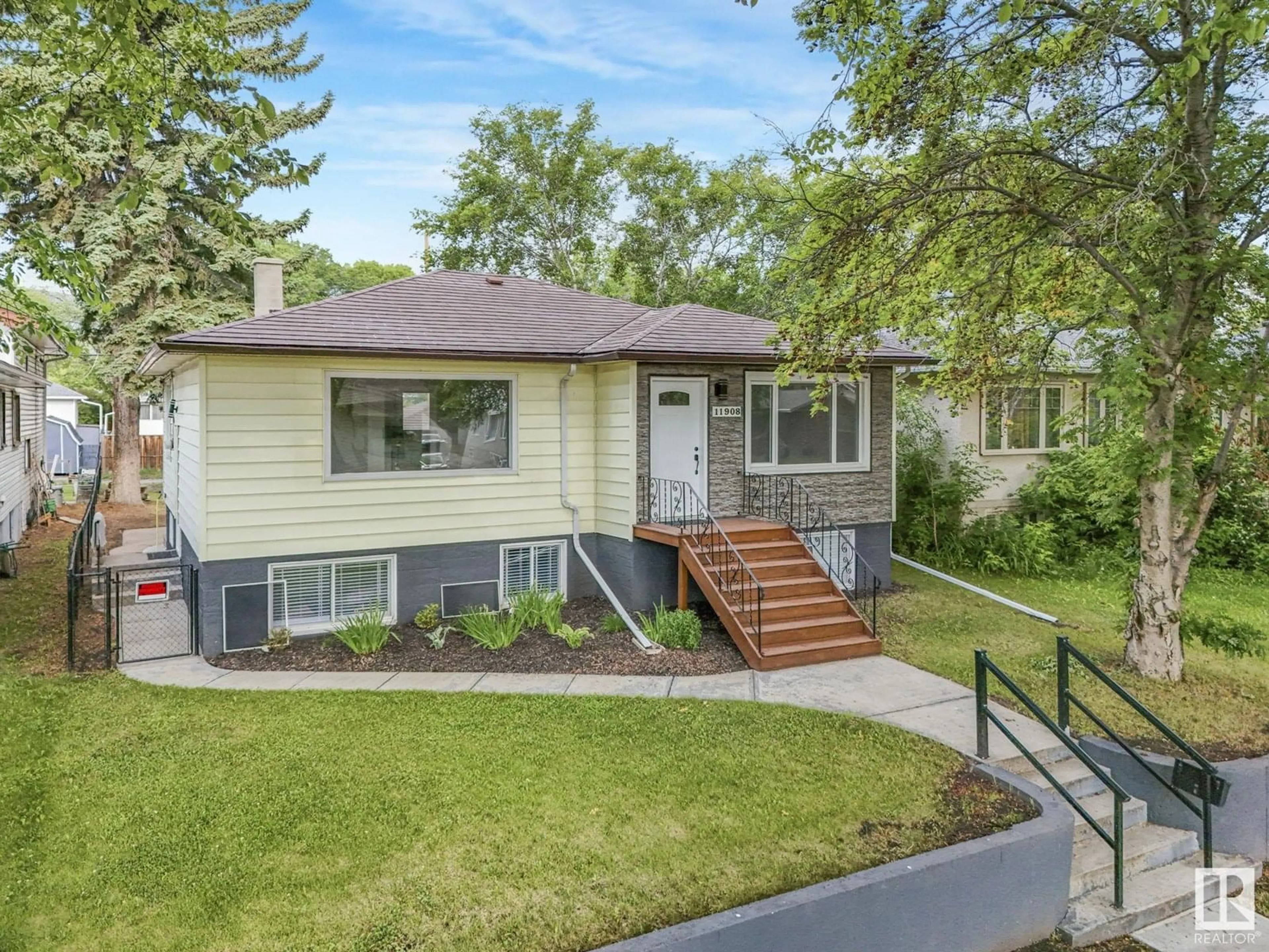 Home with vinyl exterior material, street for NW - 11908 52 ST, Edmonton Alberta T5W3J6