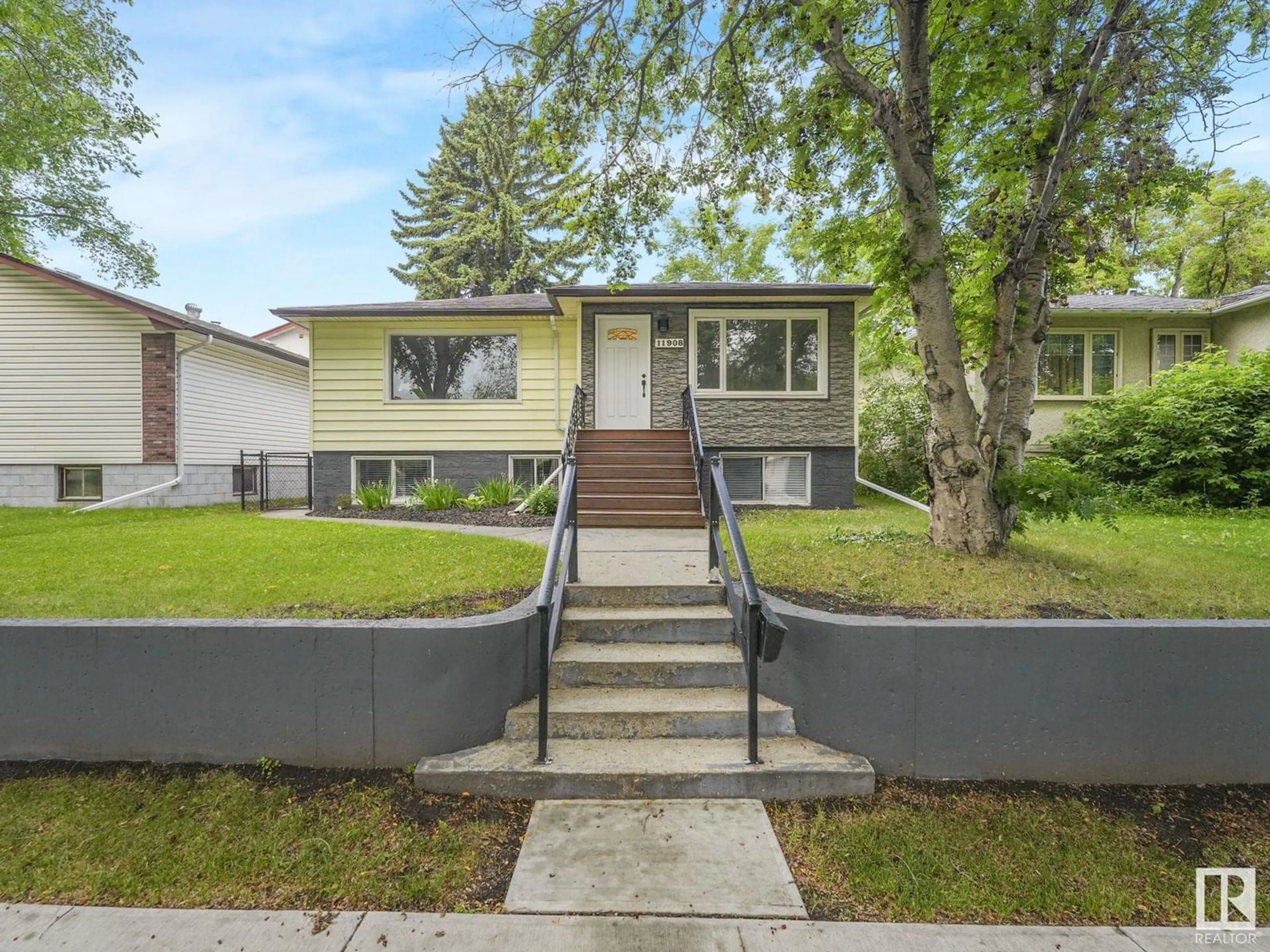 Home with vinyl exterior material, street for NW - 11908 52 ST, Edmonton Alberta T5W3J6
