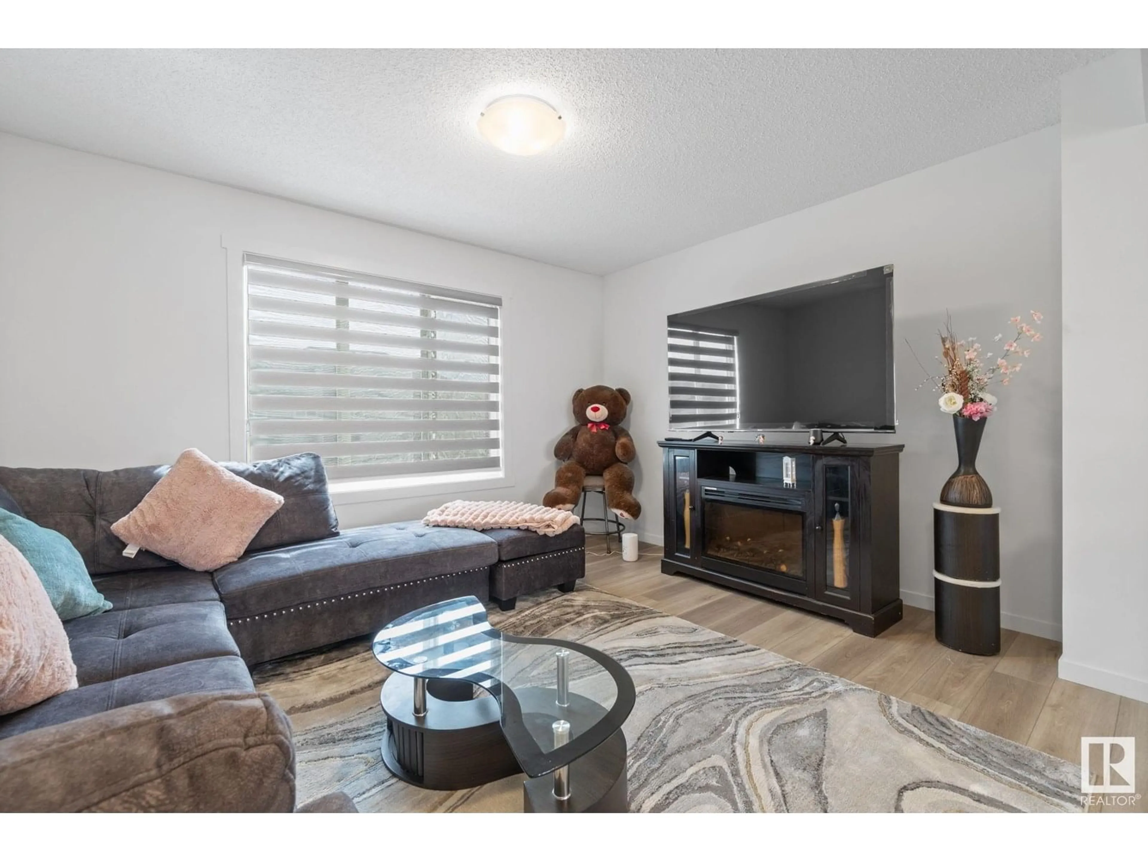 Living room with furniture, wood/laminate floor for 22727 84 AV, Edmonton Alberta T5T4B4