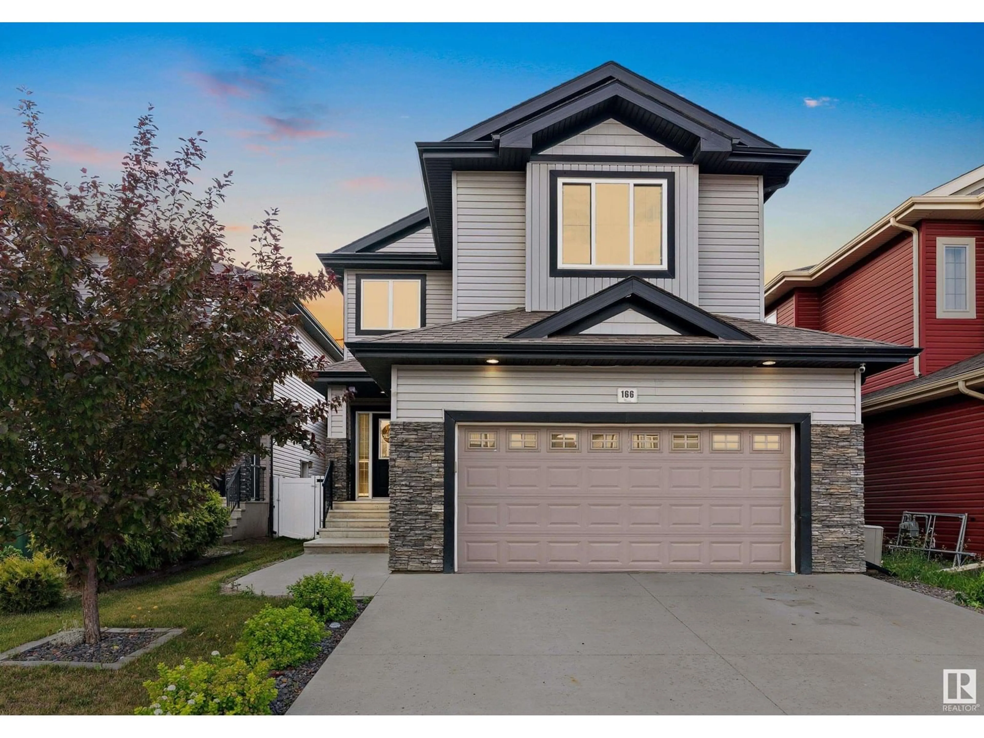 Home with vinyl exterior material, street for 166 WOODHILL LN, Fort Saskatchewan Alberta T8L0L5