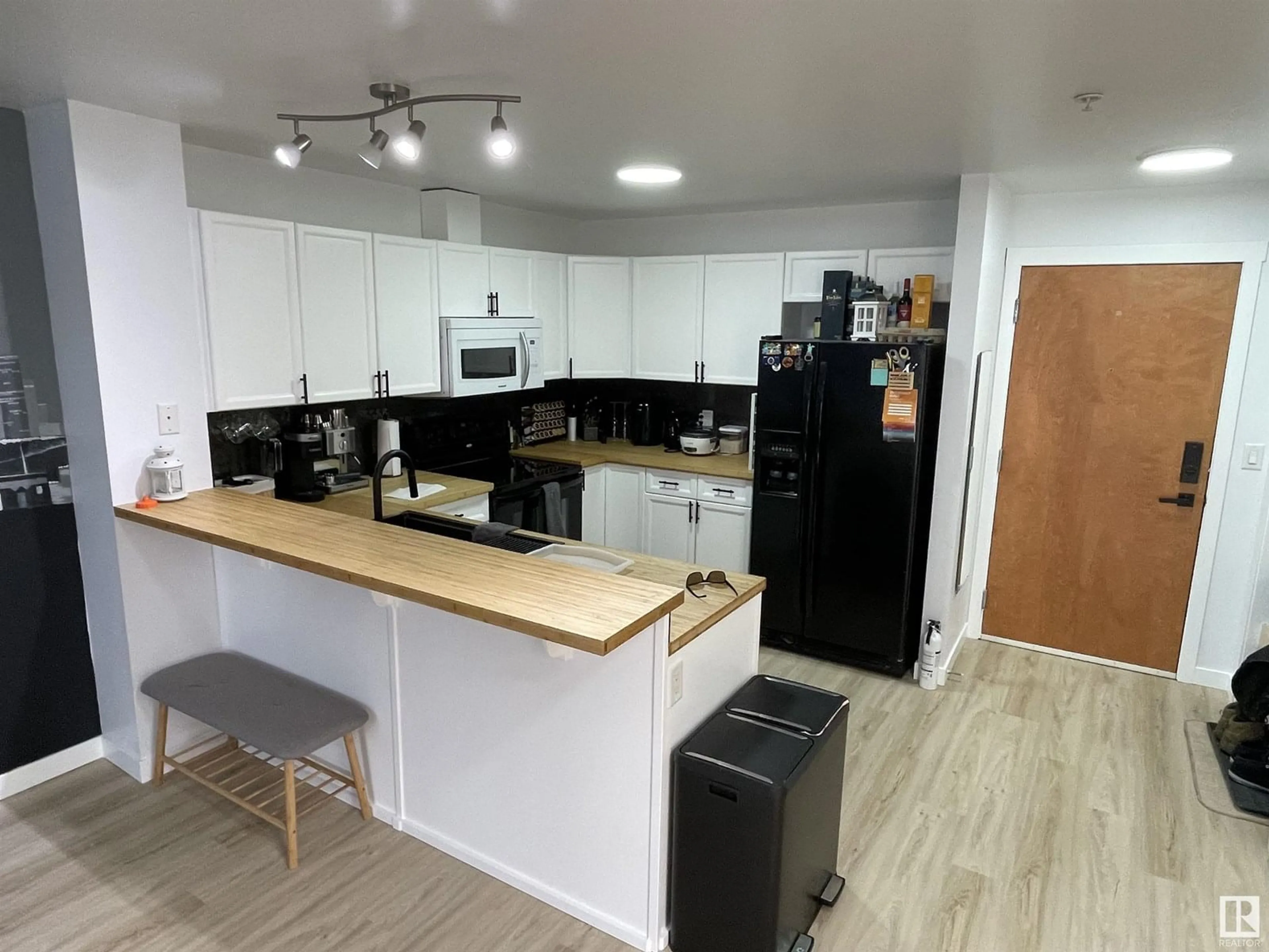 Open concept kitchen, wood/laminate floor for #311 - 13710 150 AV, Edmonton Alberta T6V0B2