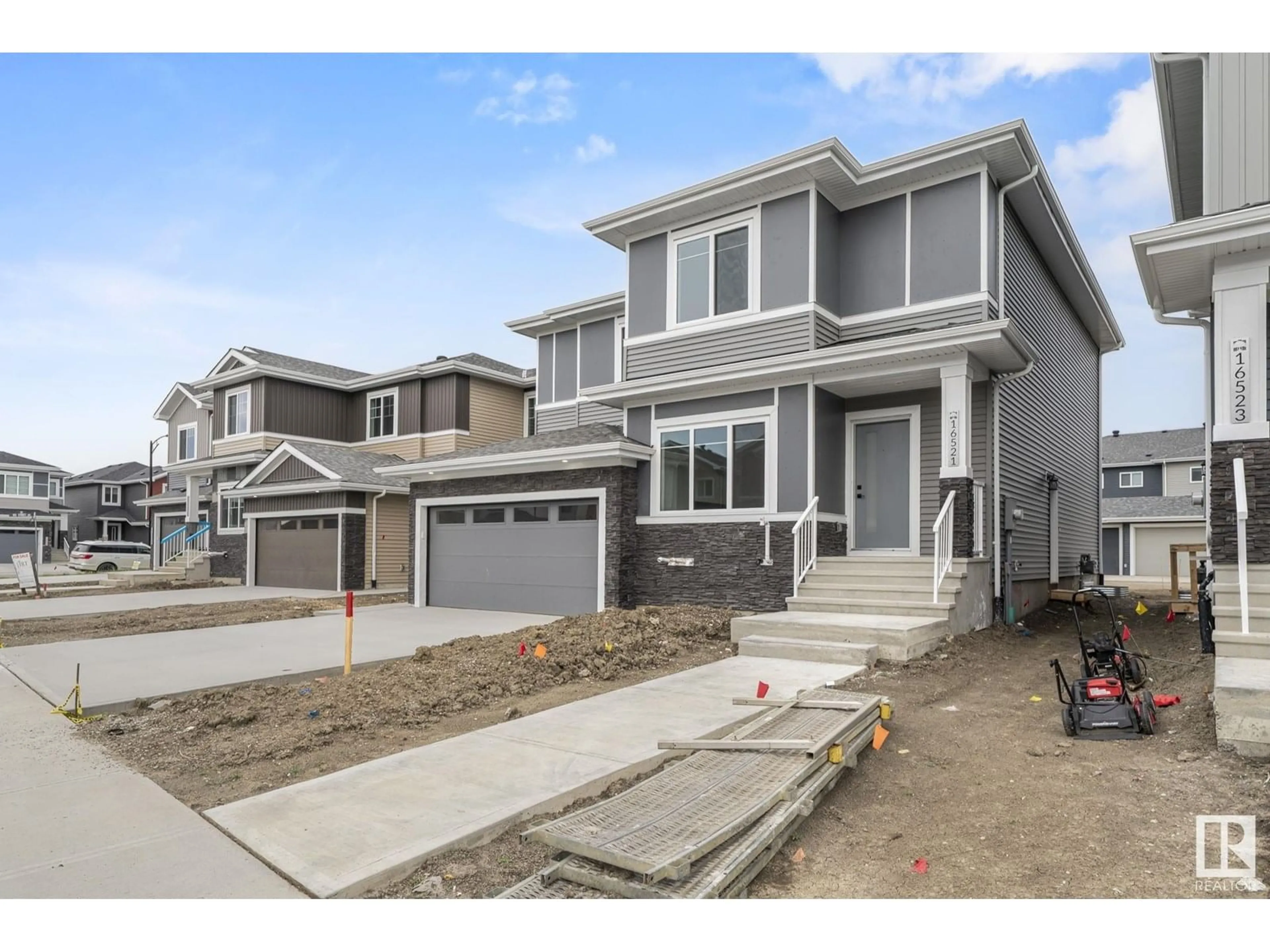 Home with vinyl exterior material, street for 16521 20 AV SW, Edmonton Alberta T6W5K1