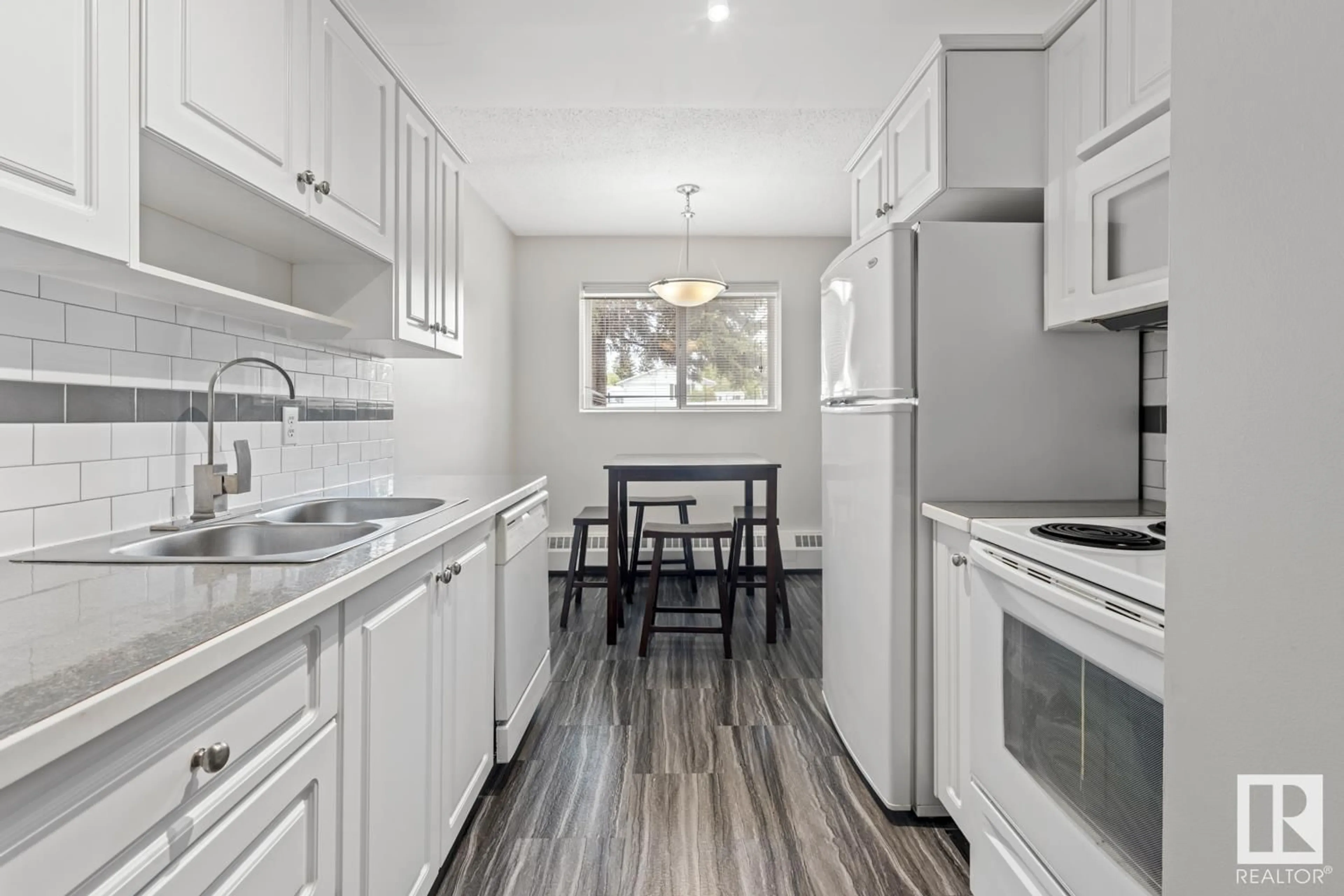 Open concept kitchen, wood/laminate floor for #103 - 911 10 ST, Cold Lake Alberta T9M1J8