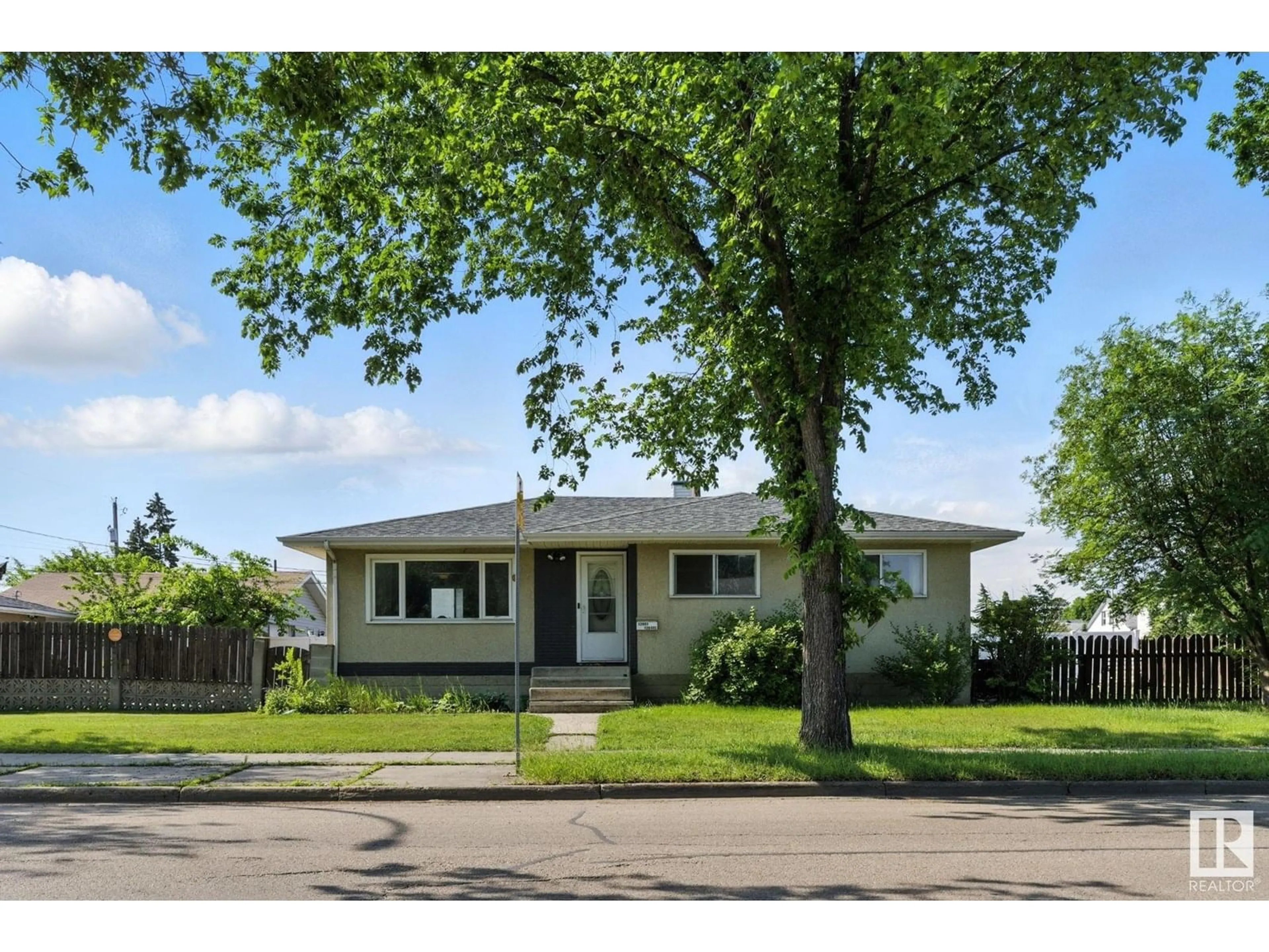 Home with vinyl exterior material, street for 12807 129 AV NW, Edmonton Alberta T5L3J7