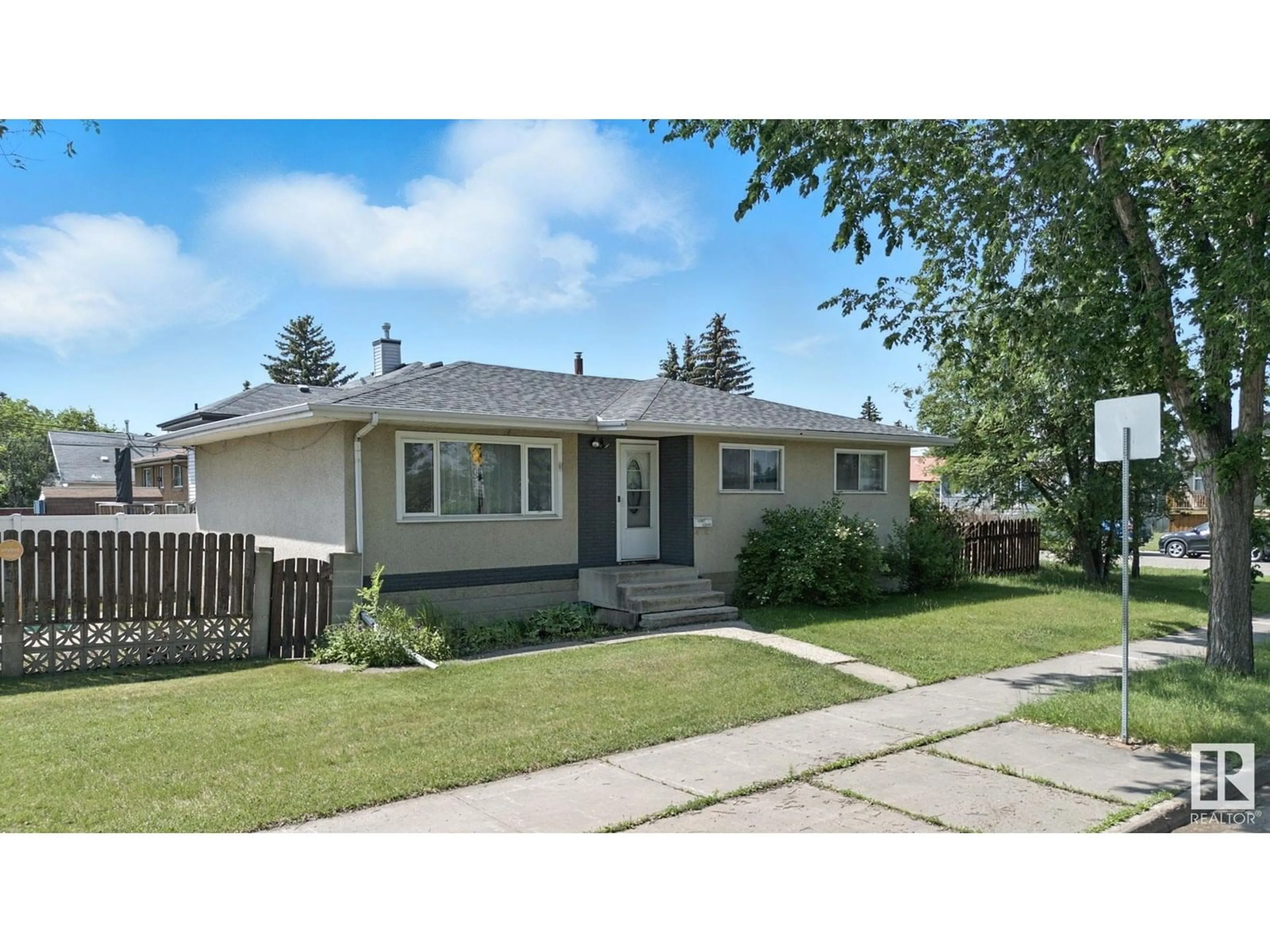 Home with vinyl exterior material, street for 12807 129 AV NW, Edmonton Alberta T5L3J7