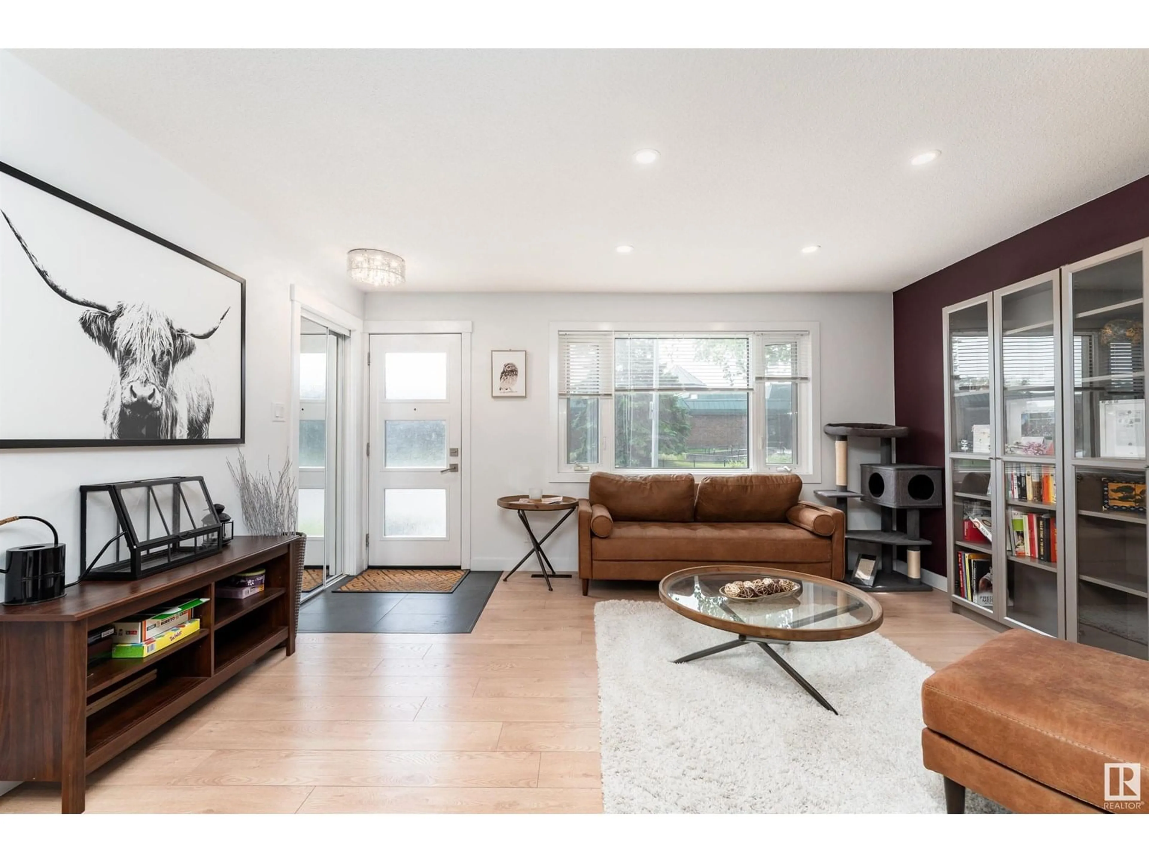 Living room with furniture, wood/laminate floor for 6712 86 AV, Edmonton Alberta T6B2G6