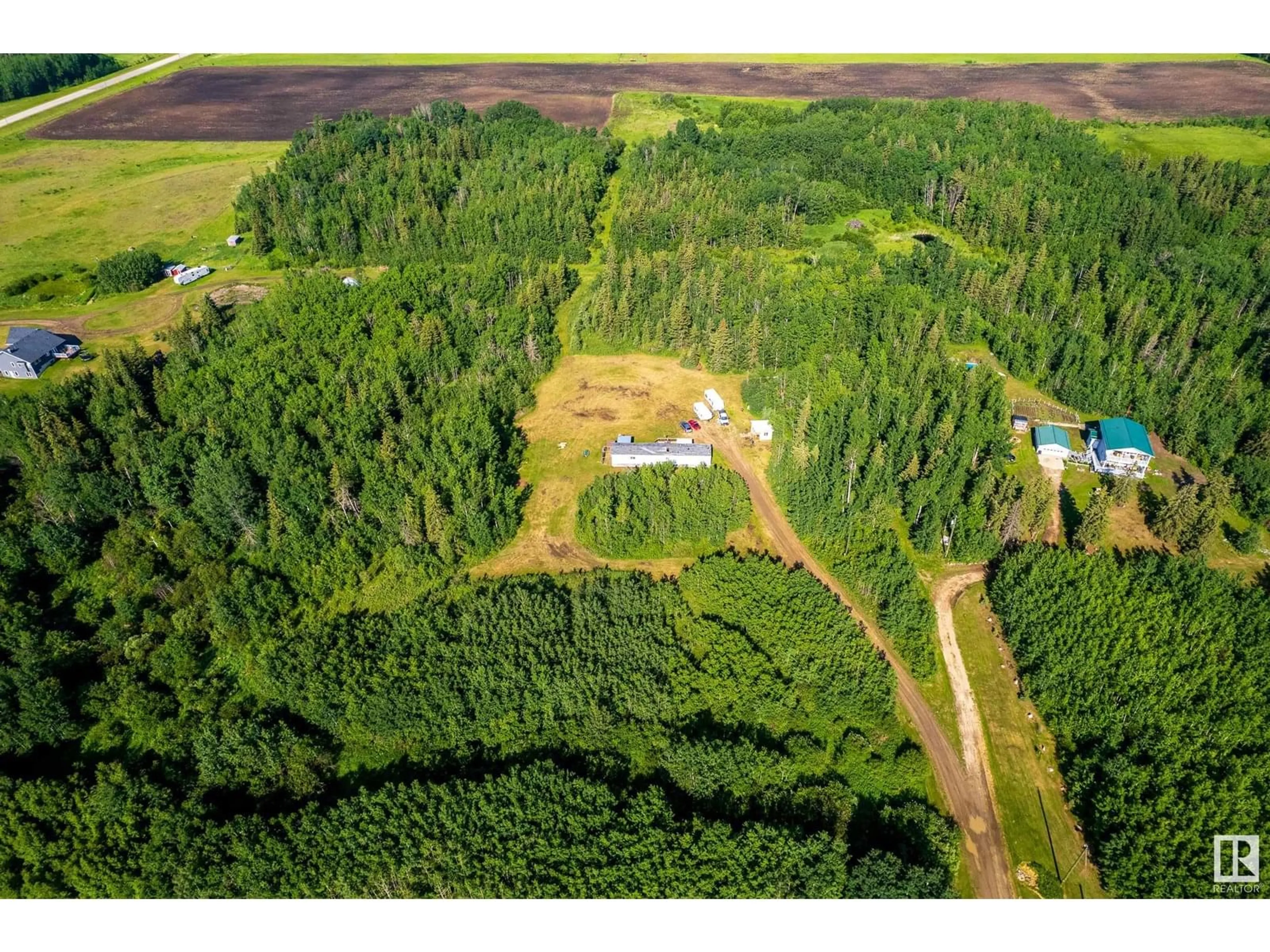 A pic from outside/outdoor area/front of a property/back of a property/a pic from drone, forest/trees view for 56008 RGE ROAD 20A, Rural Lac Ste. Anne County Alberta T0E1V0