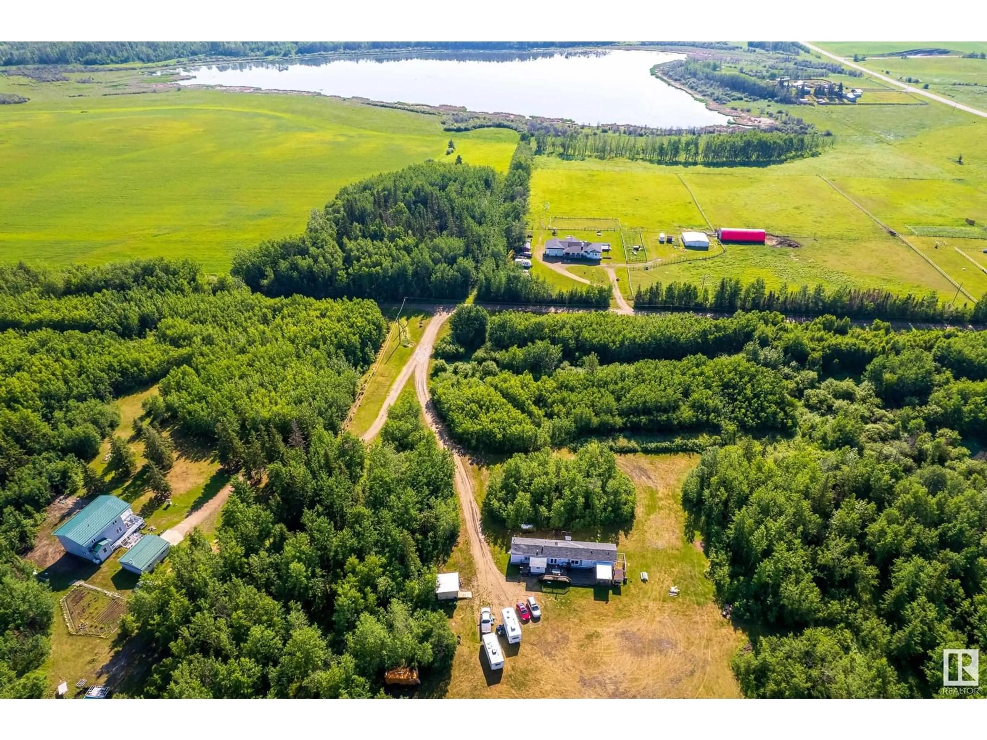 A pic from outside/outdoor area/front of a property/back of a property/a pic from drone, water/lake/river/ocean view for 56008 RGE ROAD 20A, Rural Lac Ste. Anne County Alberta T0E1V0