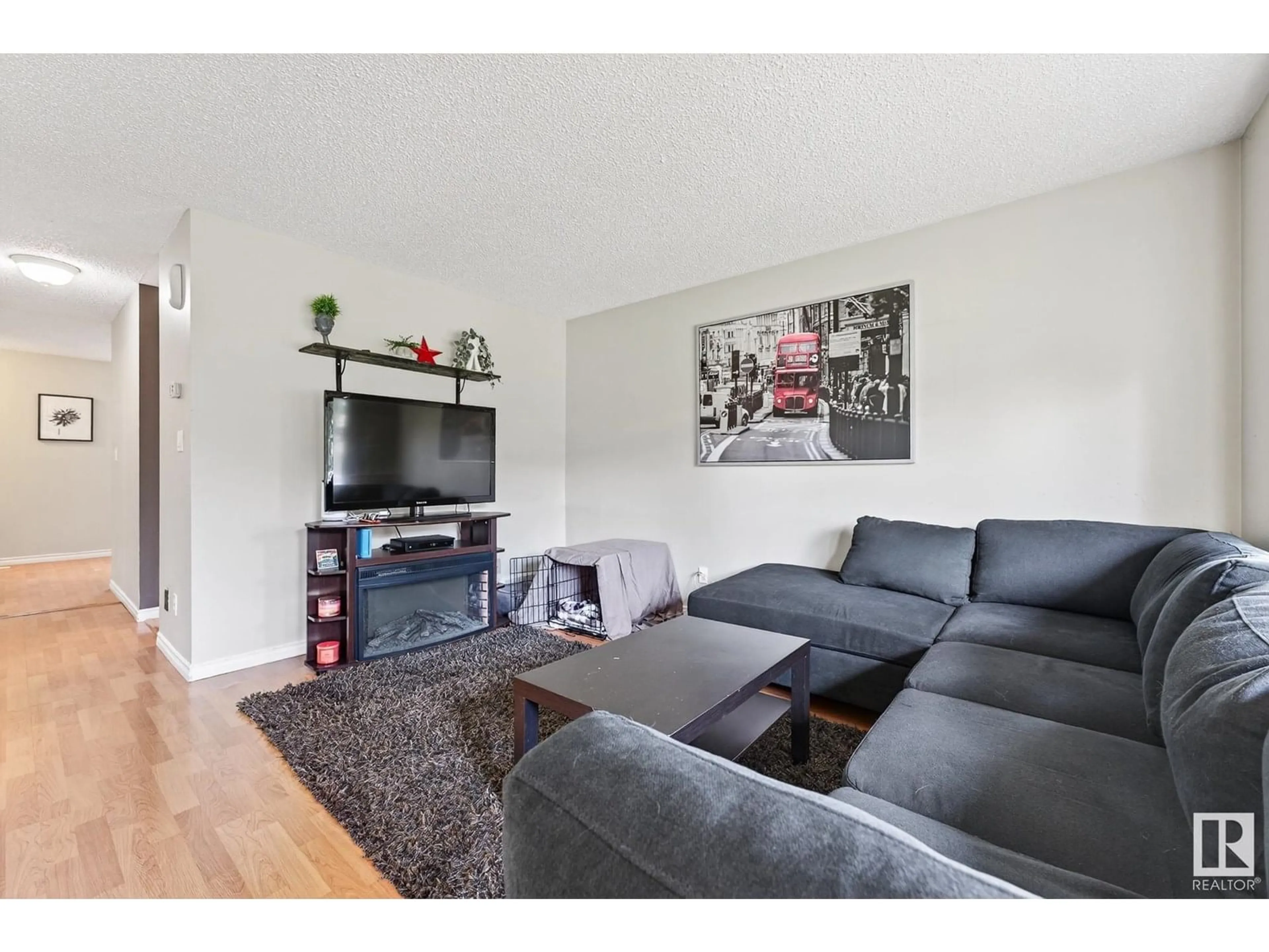 Living room with furniture, wood/laminate floor for 3512 42A AV, Edmonton Alberta T6L4N7