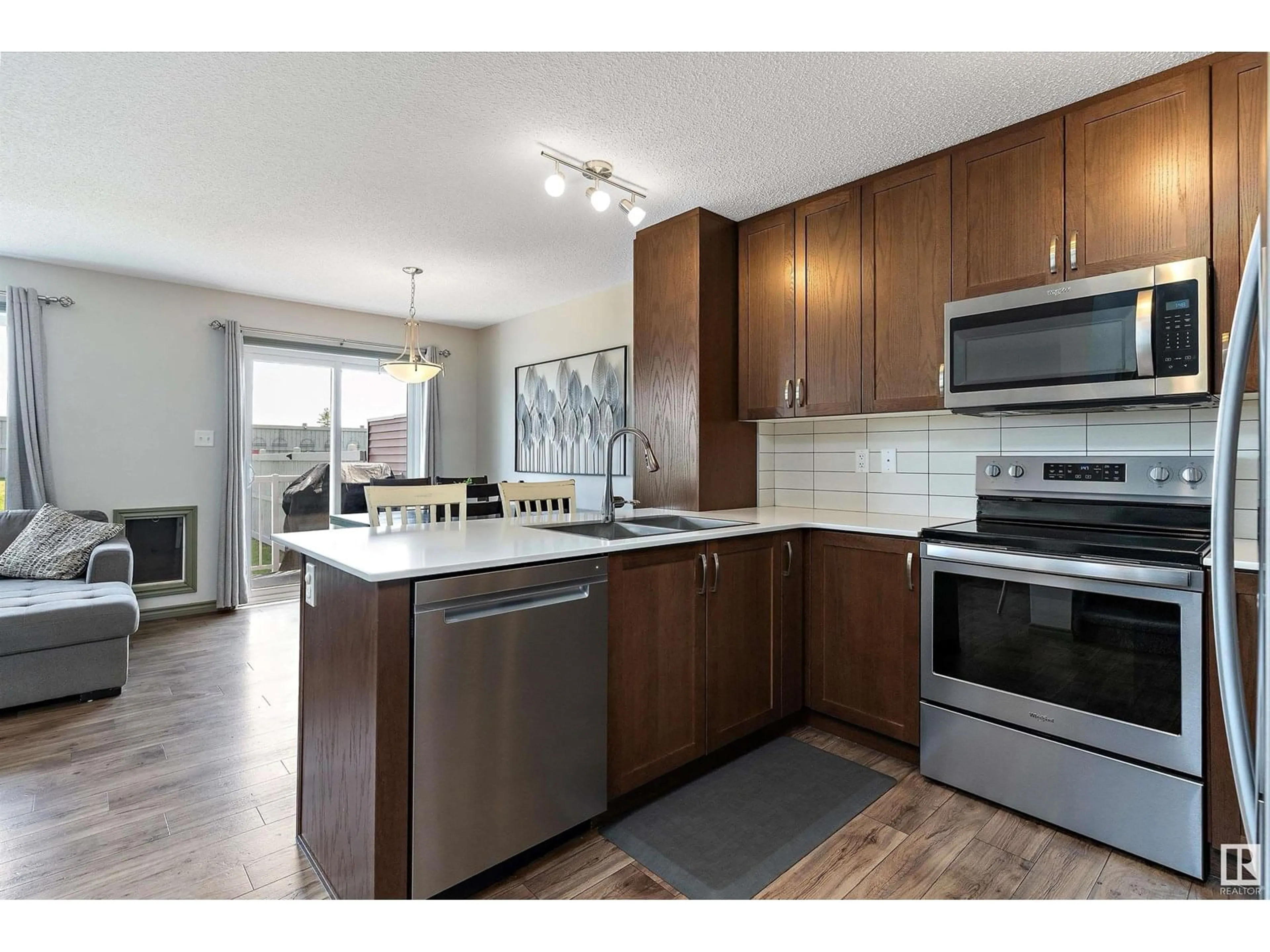 Open concept kitchen, wood/laminate floor for 507 EBBERS WY, Edmonton Alberta T5Y3T8