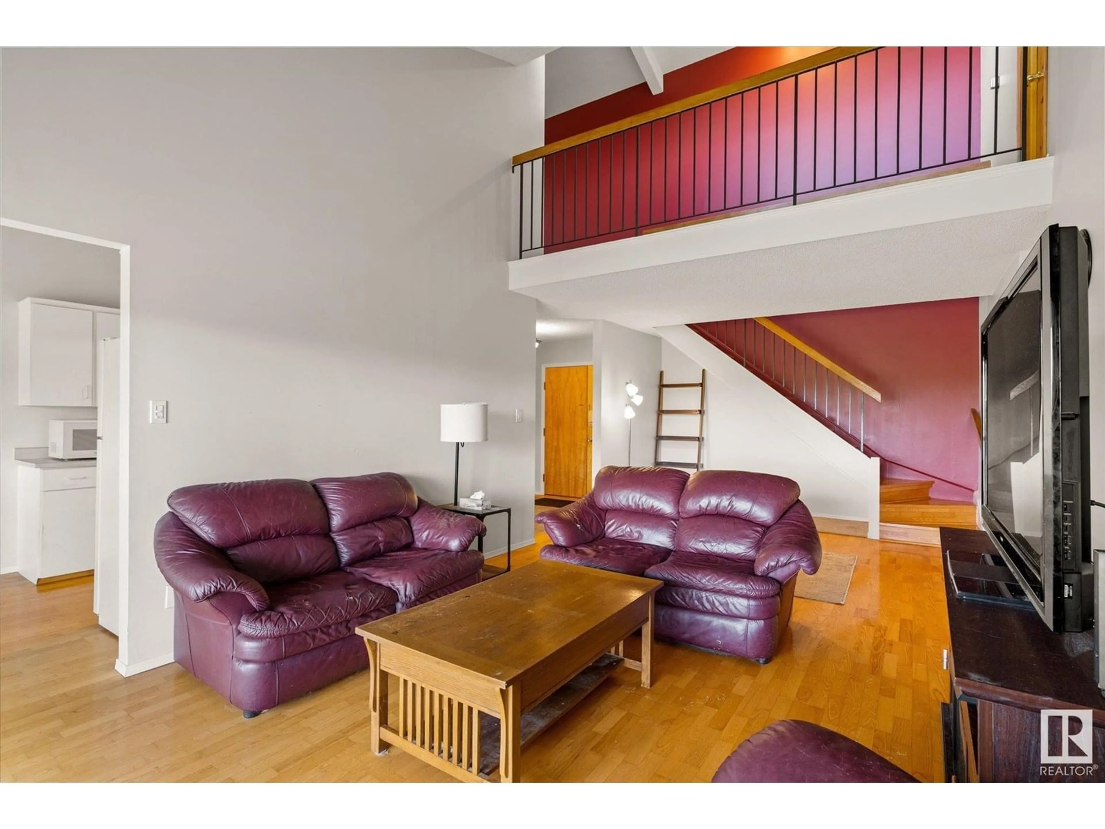 Living room with furniture, wood/laminate floor for #408 - 4404 122 ST, Edmonton Alberta T6J4A9