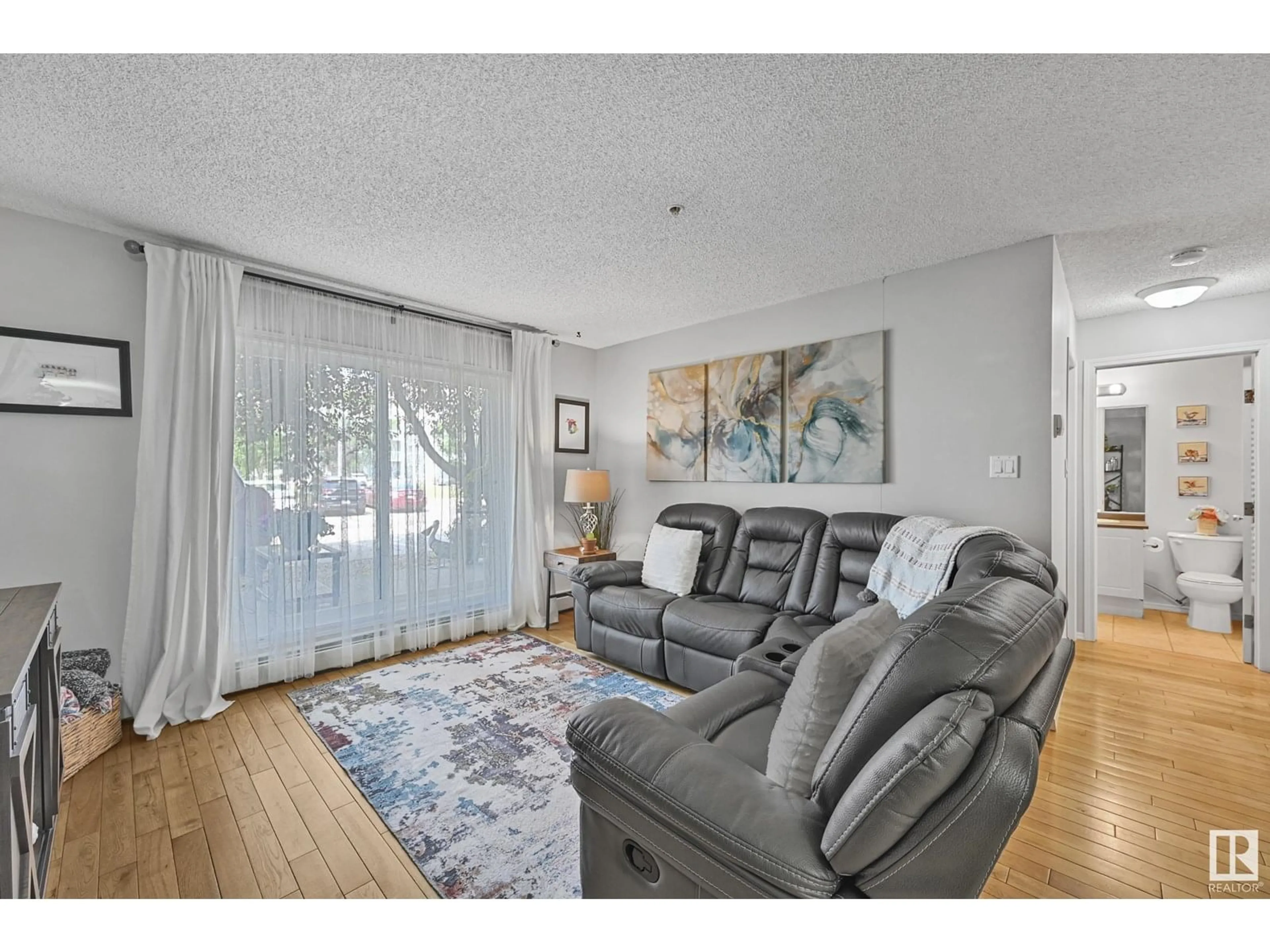 Living room with furniture, wood/laminate floor for 117 WOODSMERE CL, Fort Saskatchewan Alberta T8L4R8