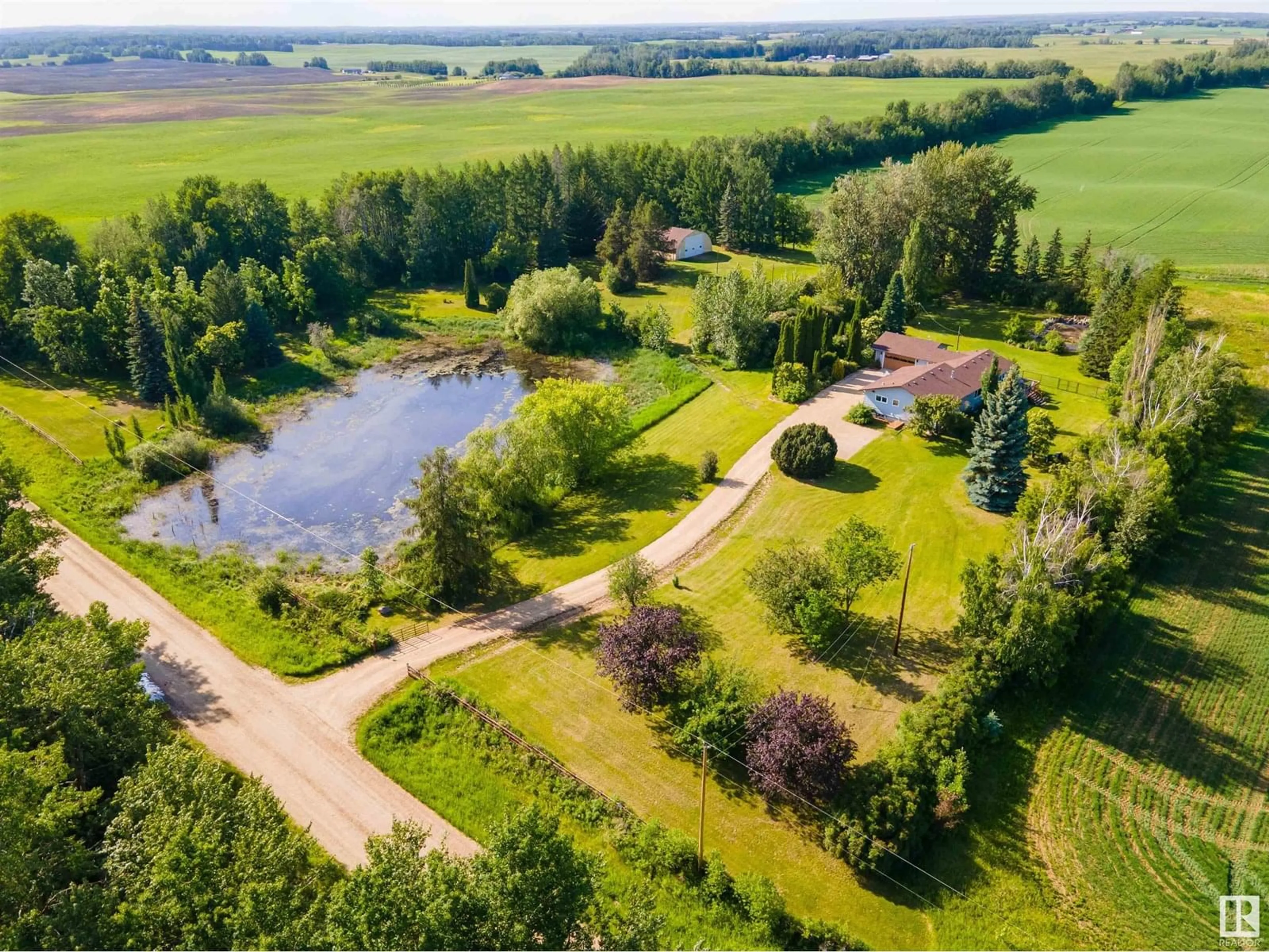 A pic from outside/outdoor area/front of a property/back of a property/a pic from drone, water/lake/river/ocean view for 1514 TWP ROAD 514, Rural Parkland County Alberta T7Y3J2