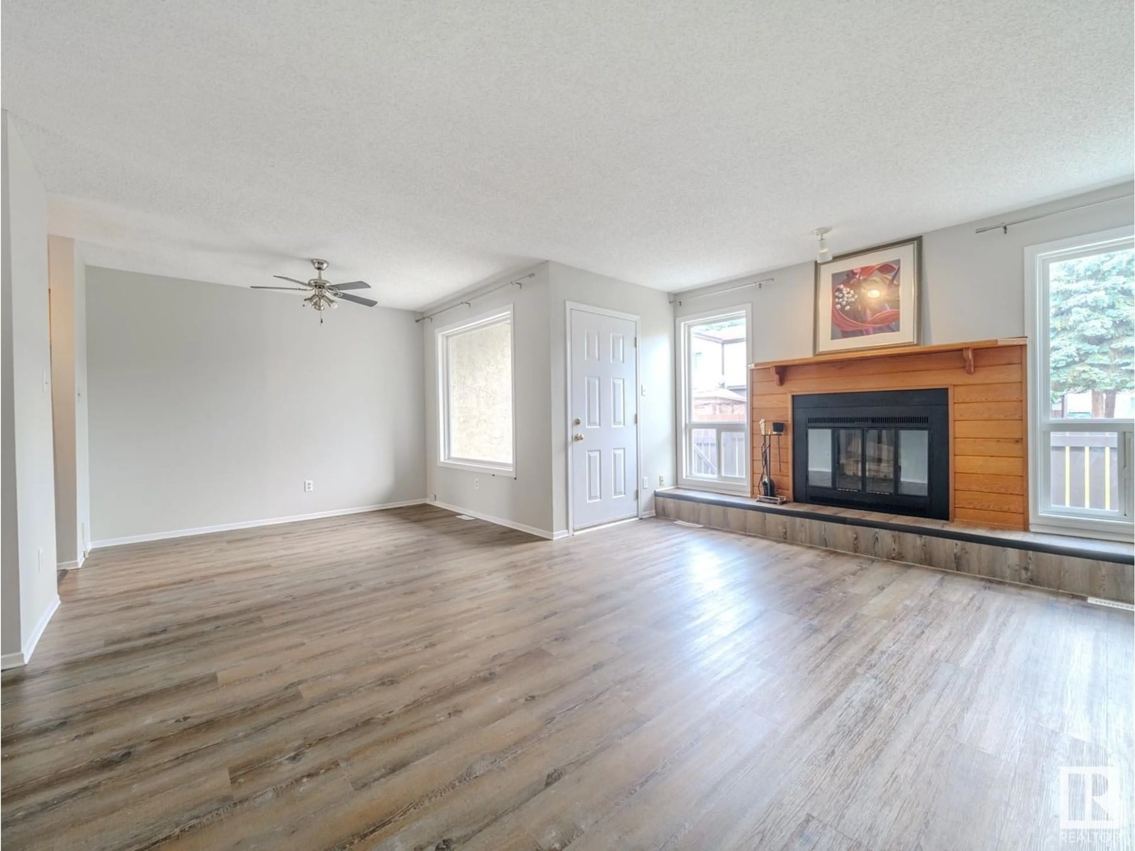 Living room with furniture, wood/laminate floor for 60 - 7604 29 AV, Edmonton Alberta T6K3Z2