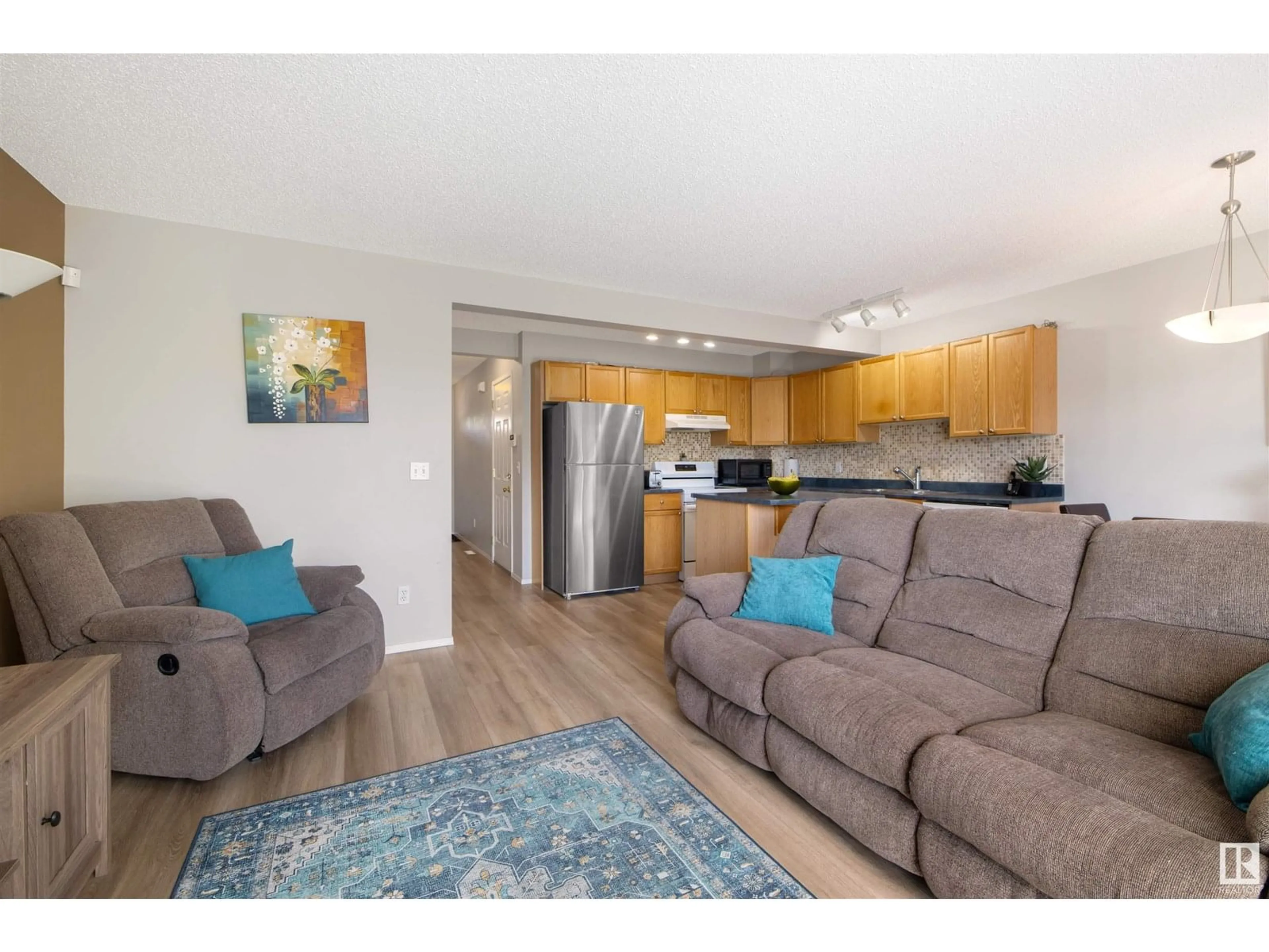 Living room with furniture, wood/laminate floor for 13077 162A AV, Edmonton Alberta T6V1W1
