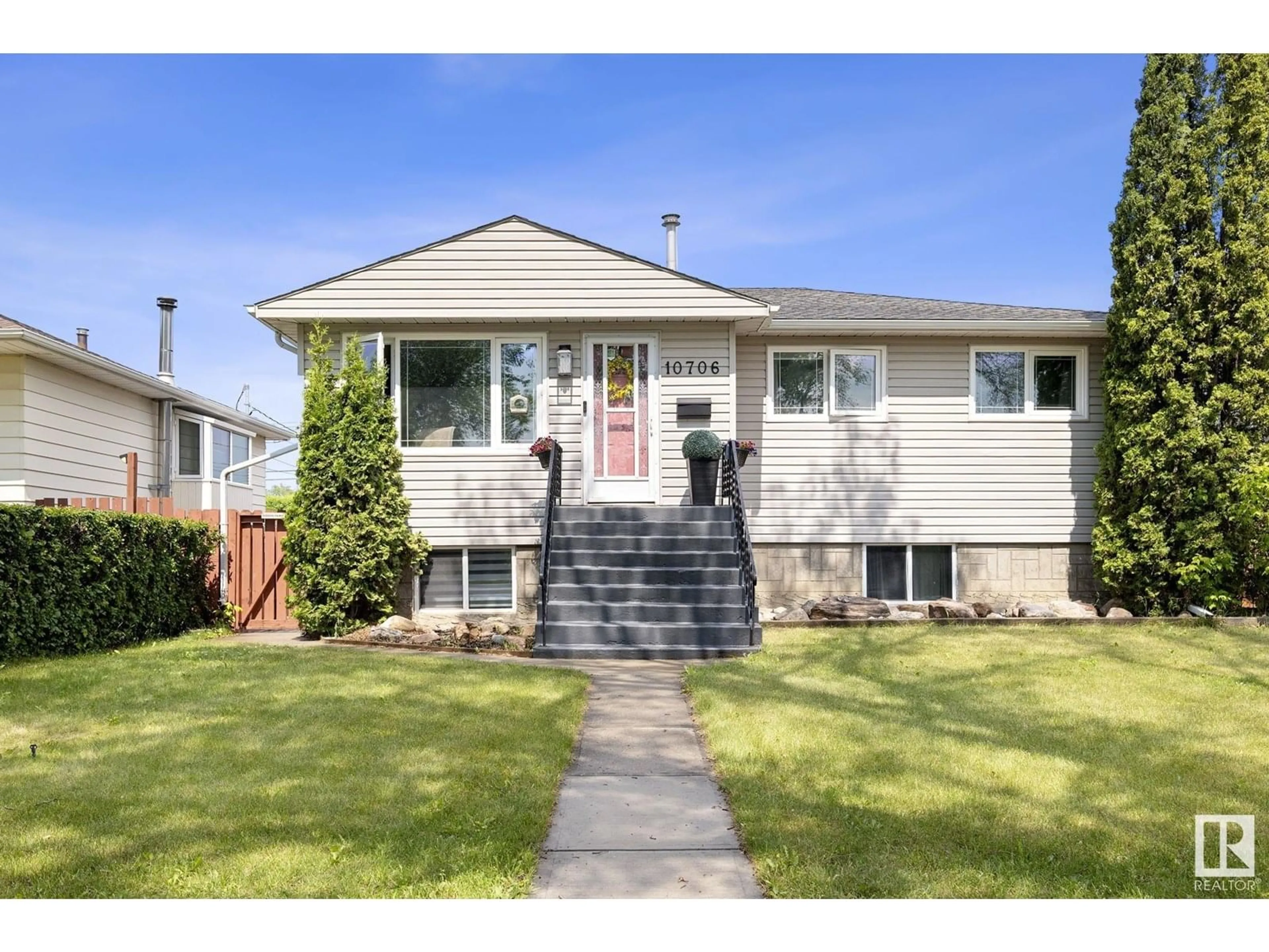 Home with vinyl exterior material, street for 10706 129 AV, Edmonton Alberta T5E0L4