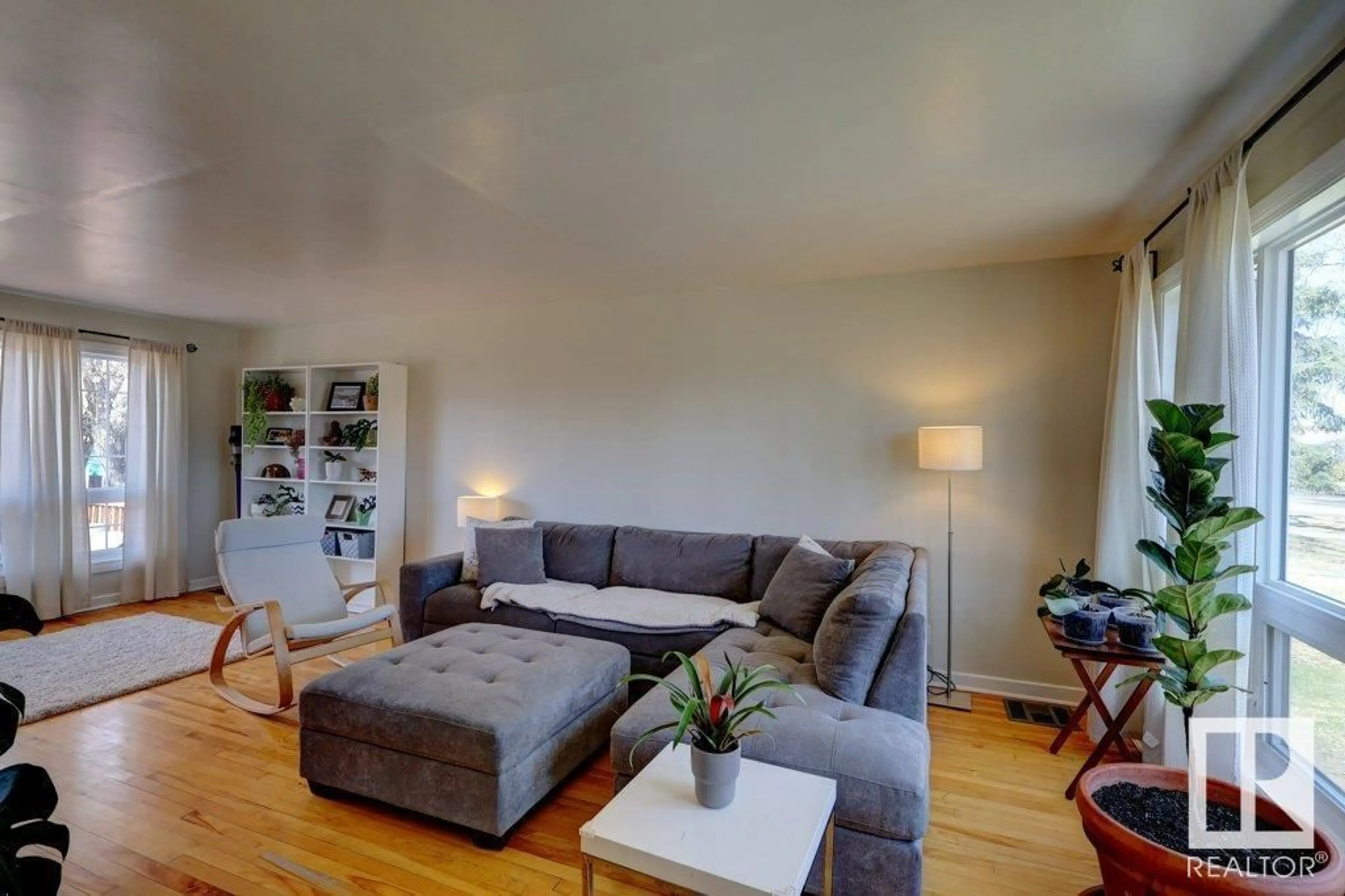 Living room with furniture, wood/laminate floor for 11434 TOWER RD, Edmonton Alberta T5G0Y8