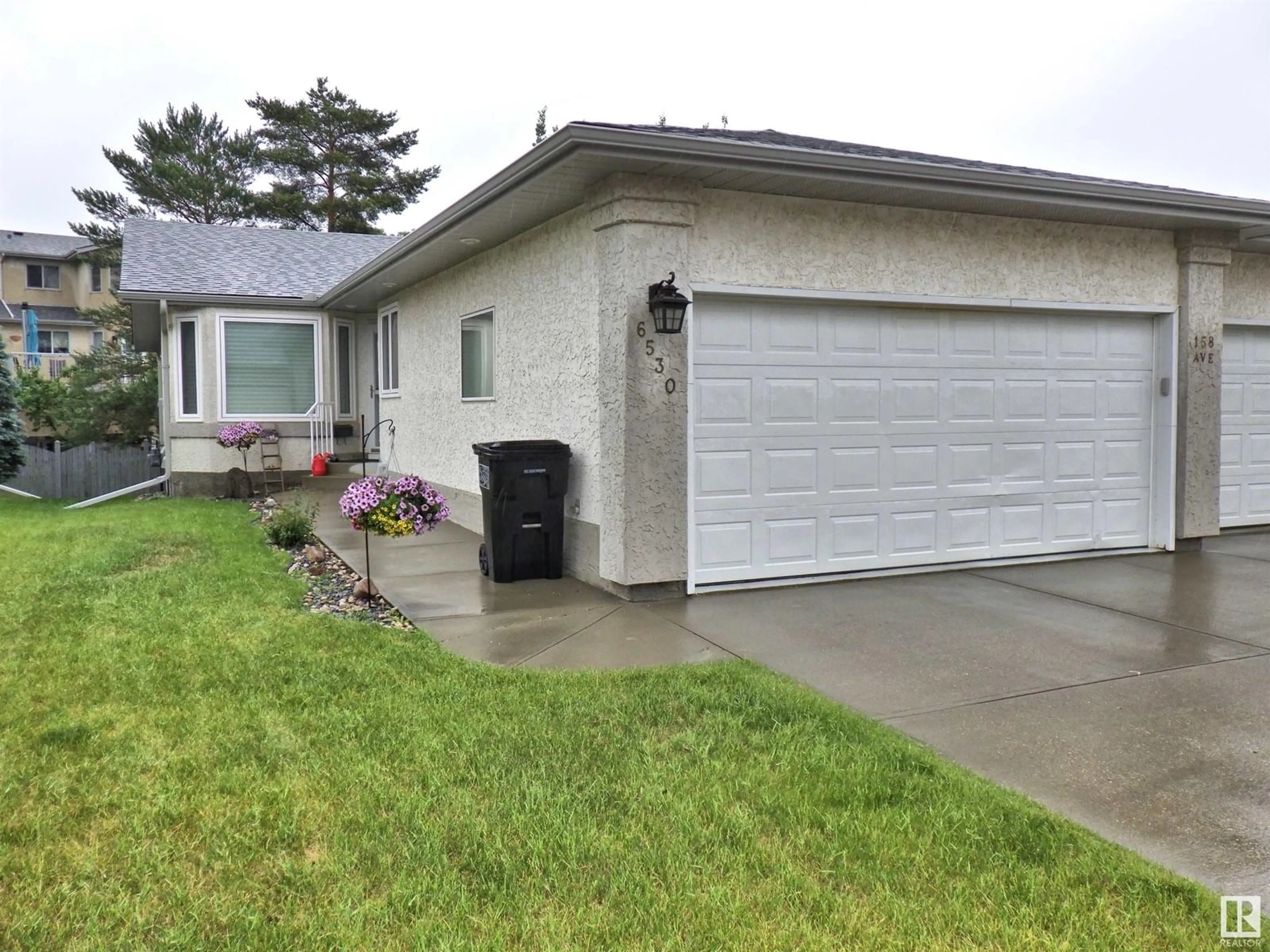 Home with vinyl exterior material, street for 6530 158 AV, Edmonton Alberta T5Y2S7