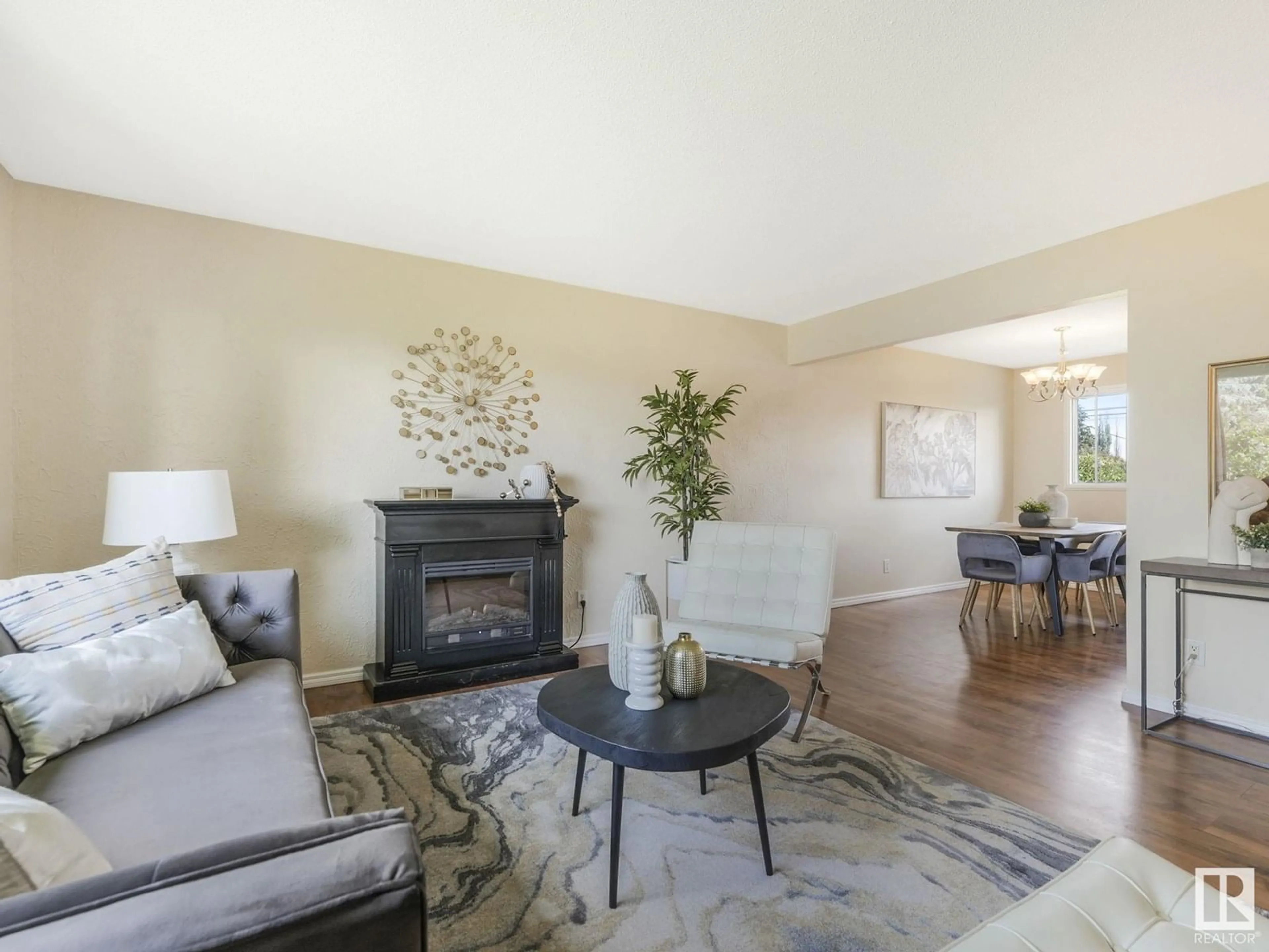 Living room with furniture, wood/laminate floor for 11703 46 AV, Edmonton Alberta T6H0A6