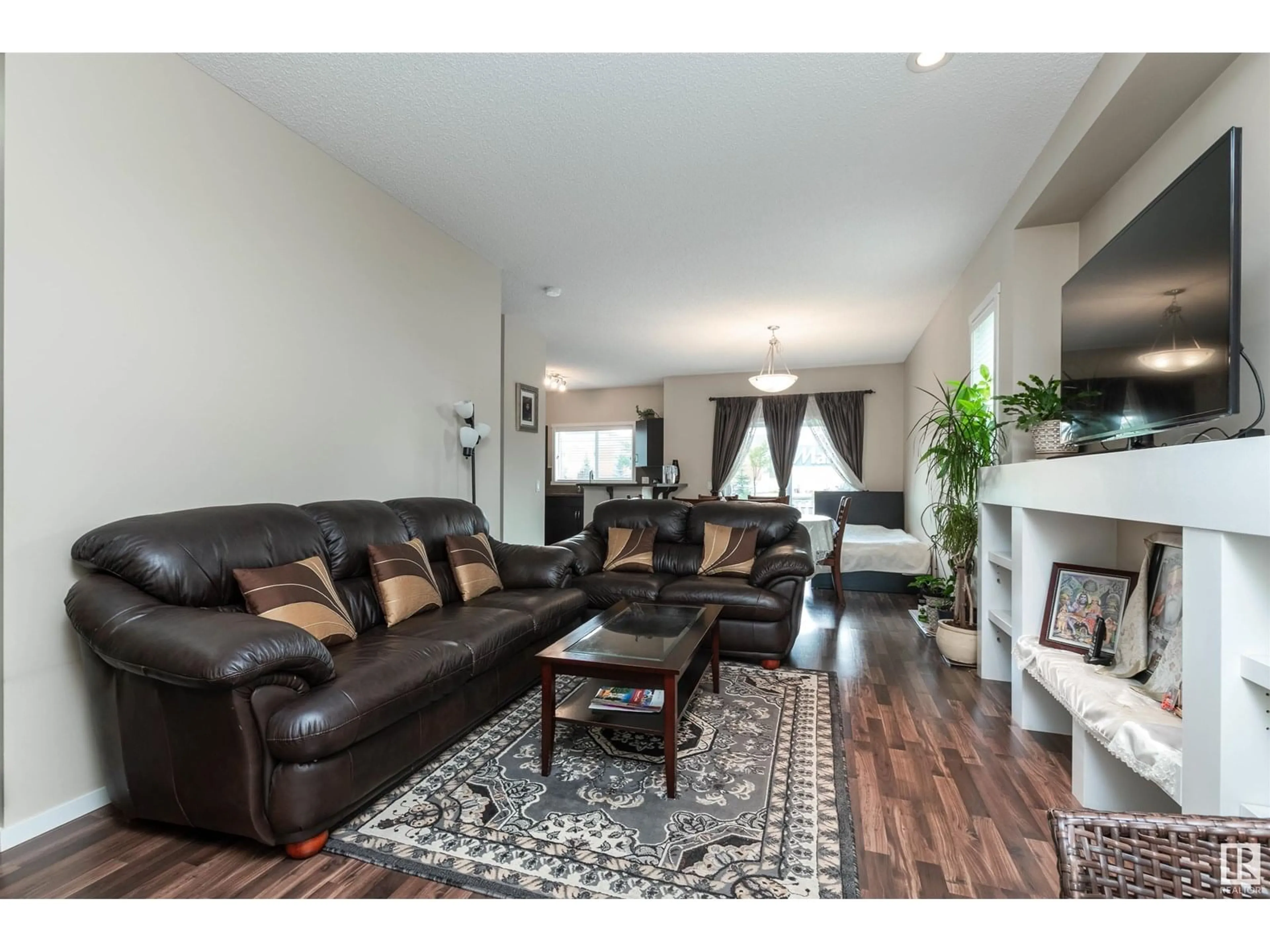 Living room with furniture, wood/laminate floor for 7526 ELLESMERE WY, Sherwood Park Alberta T8H0P6