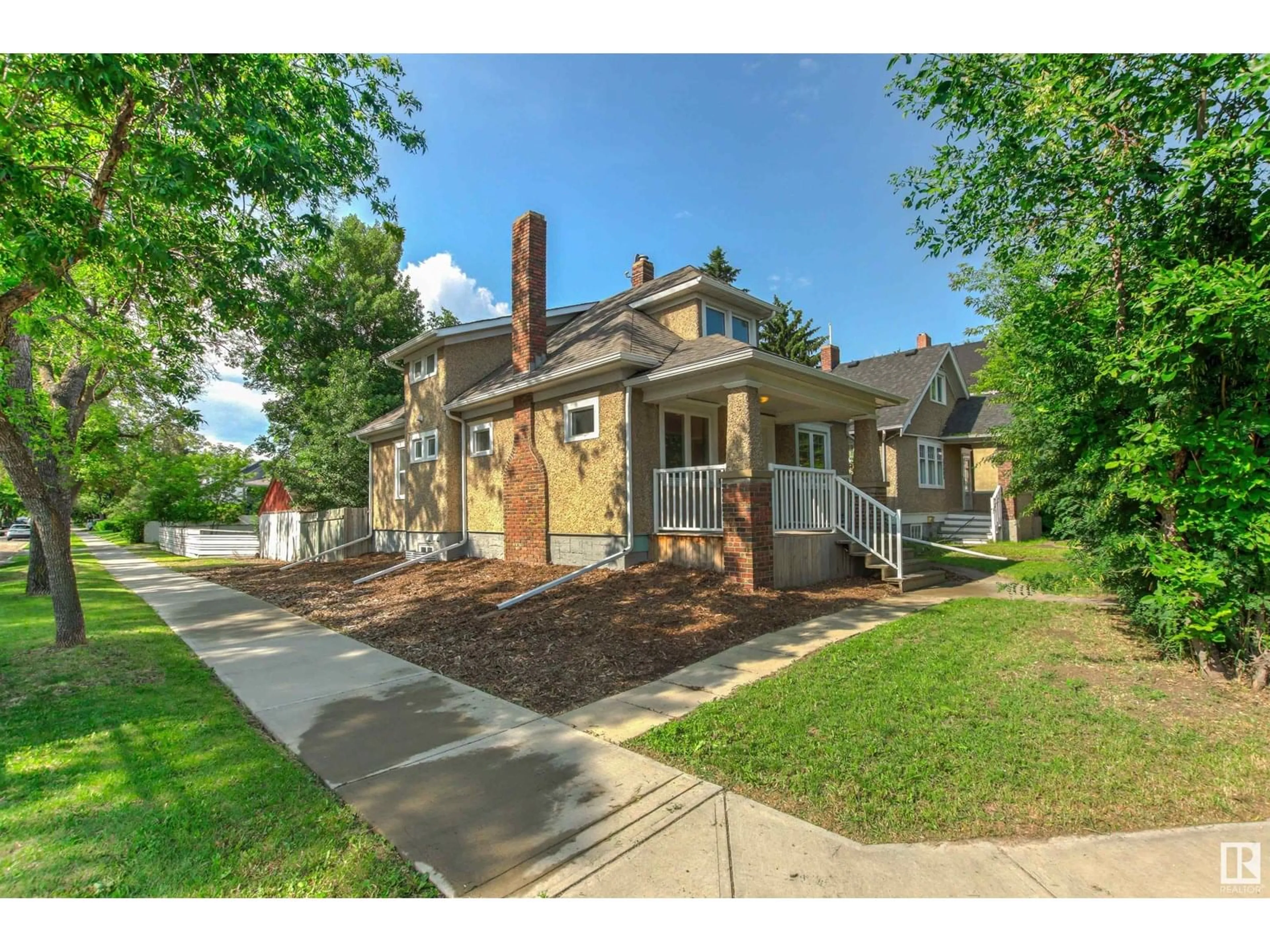 Home with brick exterior material, street for 12601 107 AV, Edmonton Alberta T5M1Z5