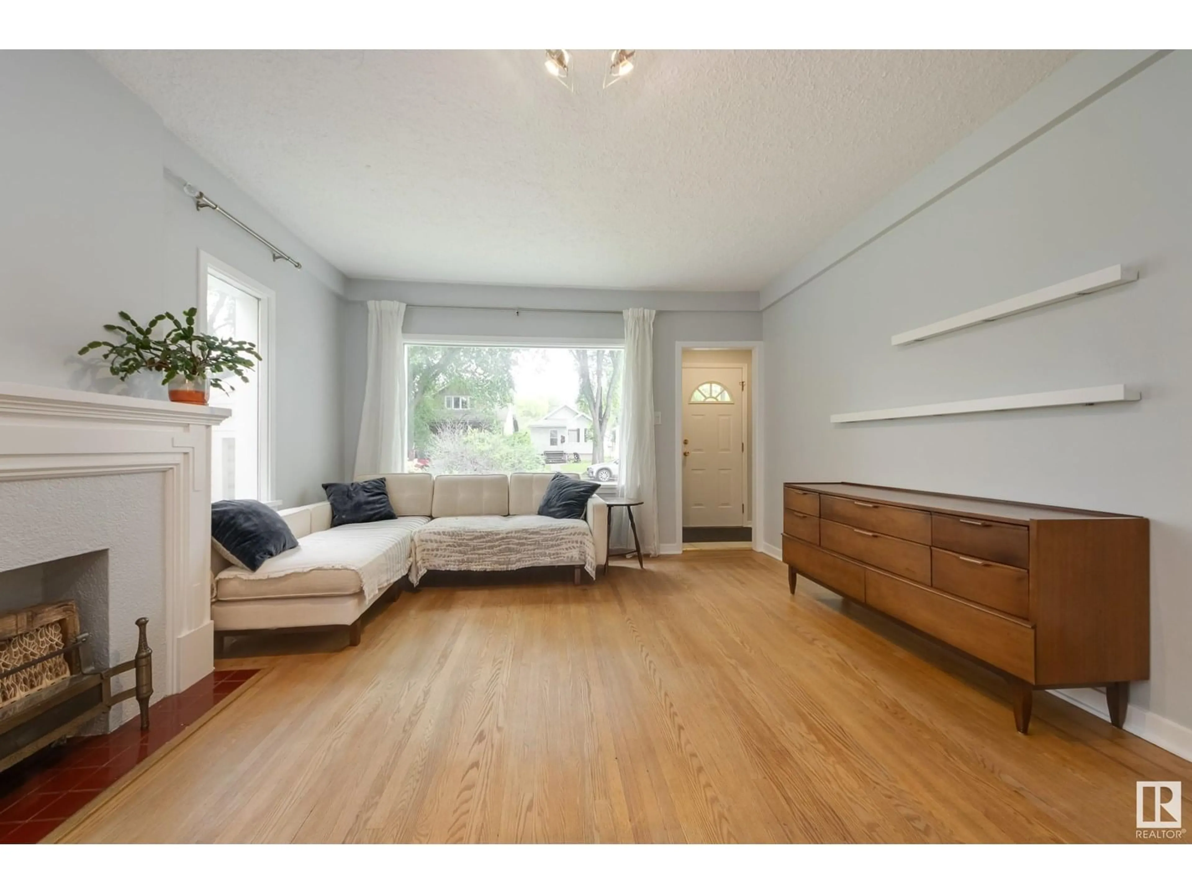 Living room with furniture, wood/laminate floor for 10817 79 AV, Edmonton Alberta T6E1S6