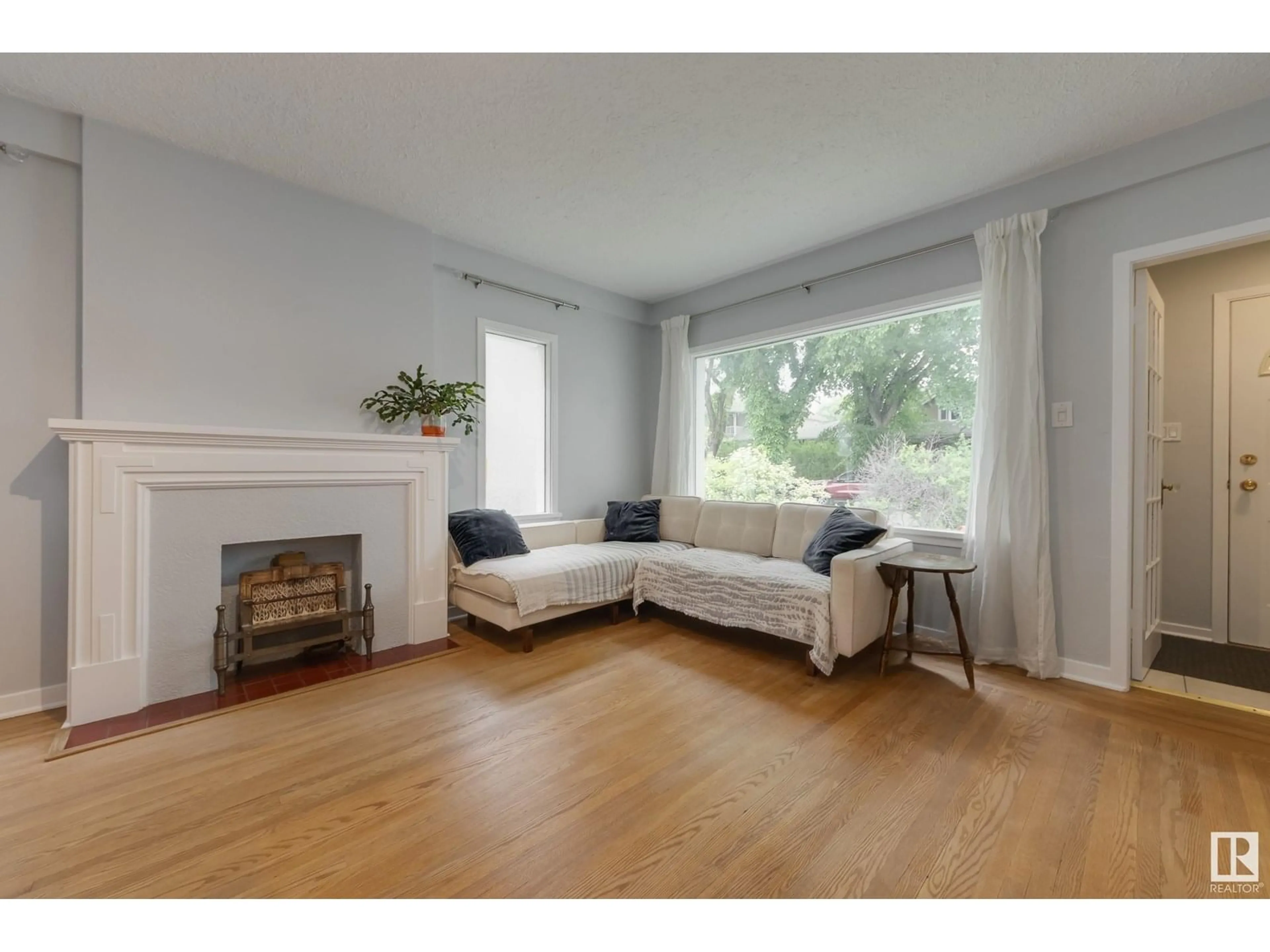 Living room with furniture, wood/laminate floor for 10817 79 AV, Edmonton Alberta T6E1S6