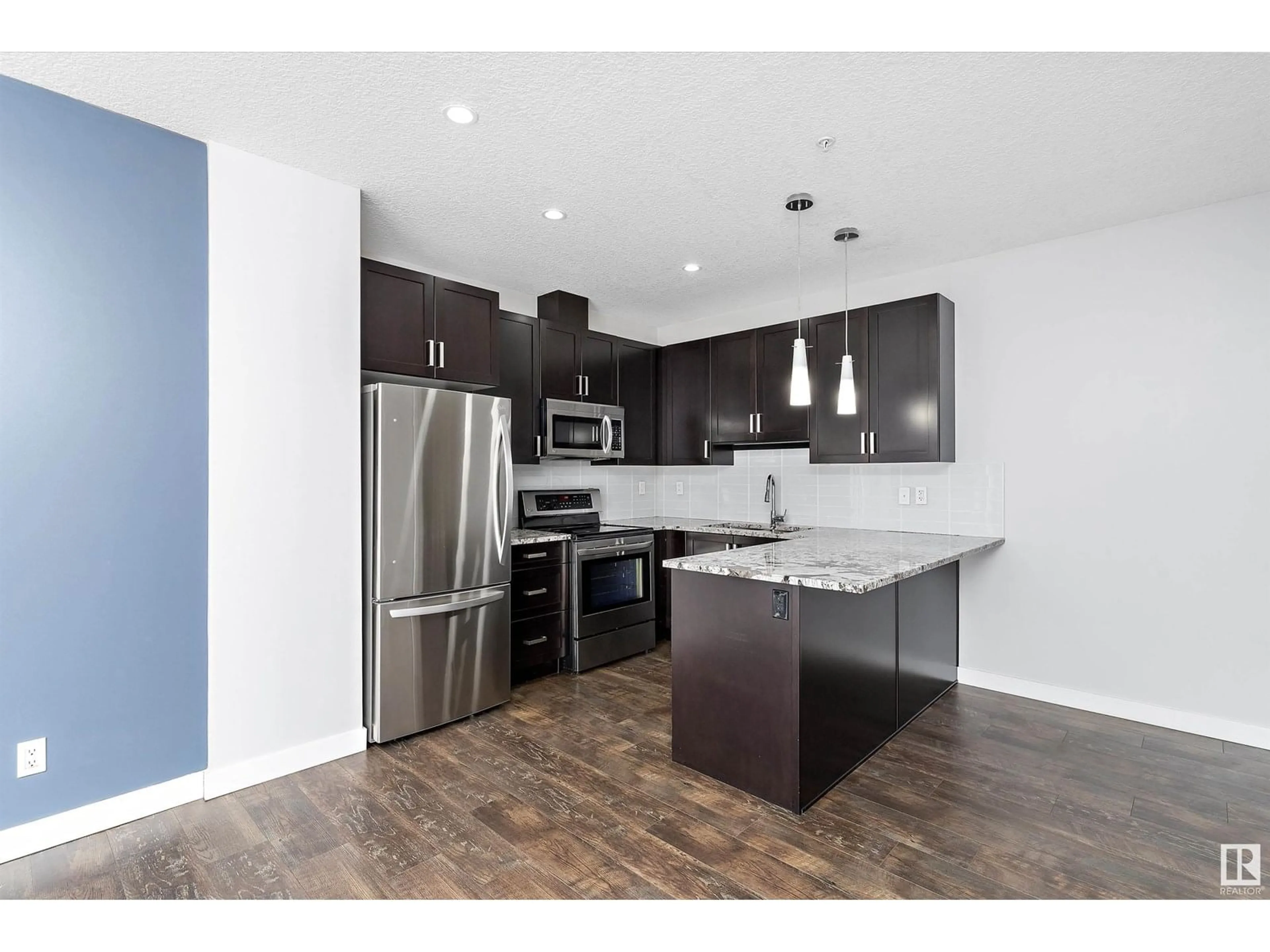 Open concept kitchen, wood/laminate floor for #302 - 10238 103 ST NW, Edmonton Alberta T5J0G6