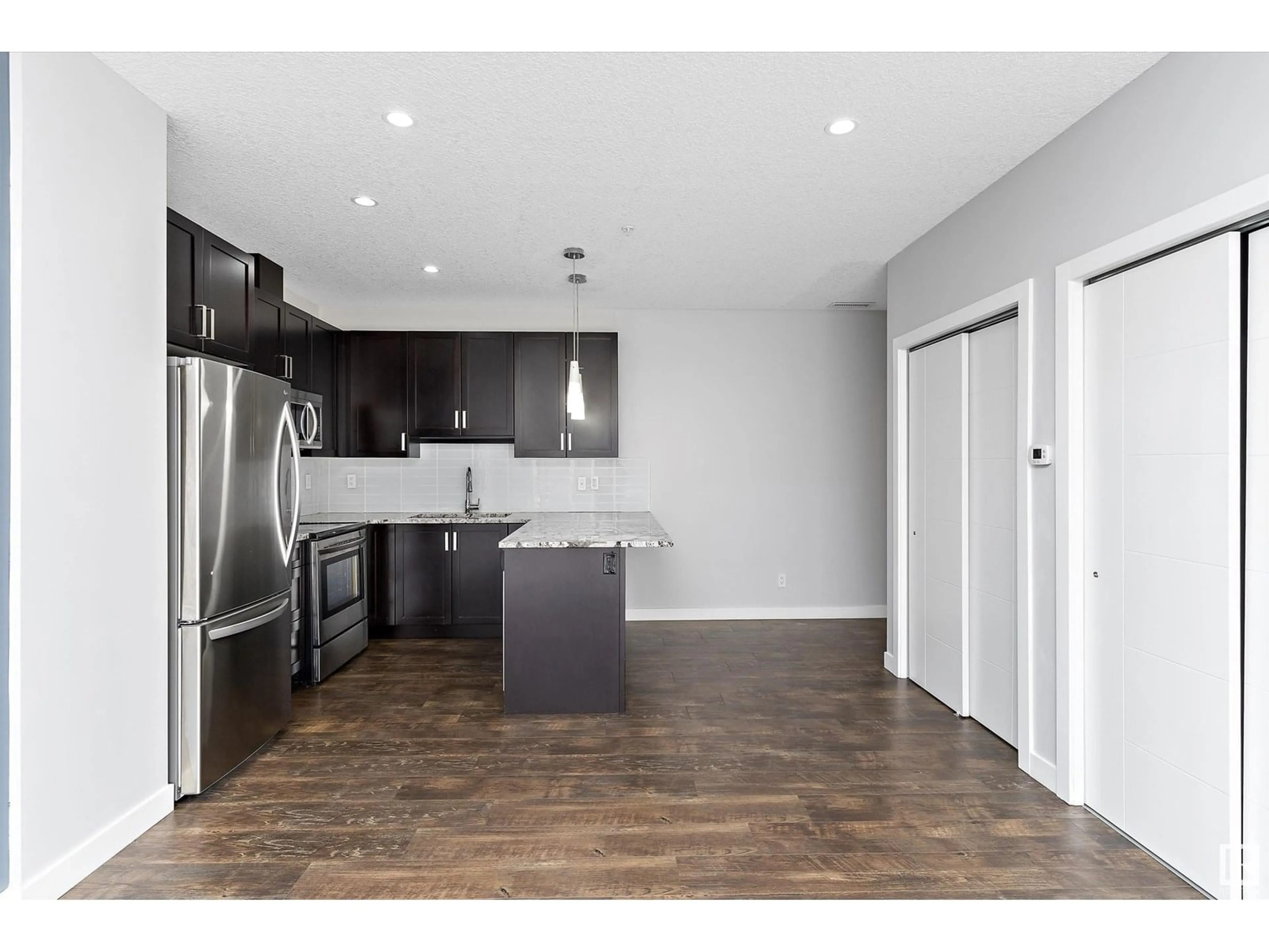 Open concept kitchen, wood/laminate floor for #302 - 10238 103 ST NW, Edmonton Alberta T5J0G6