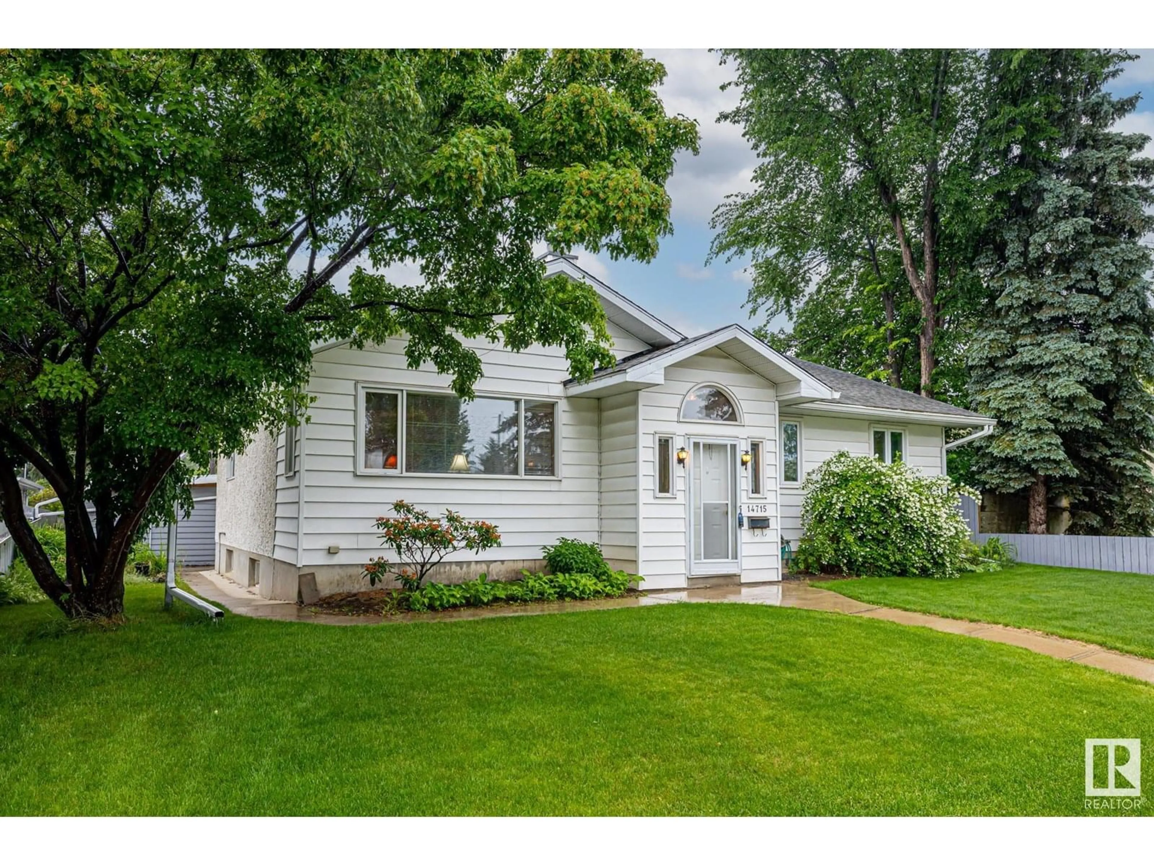 Home with vinyl exterior material, street for 14715 84 AV, Edmonton Alberta T5R3X1