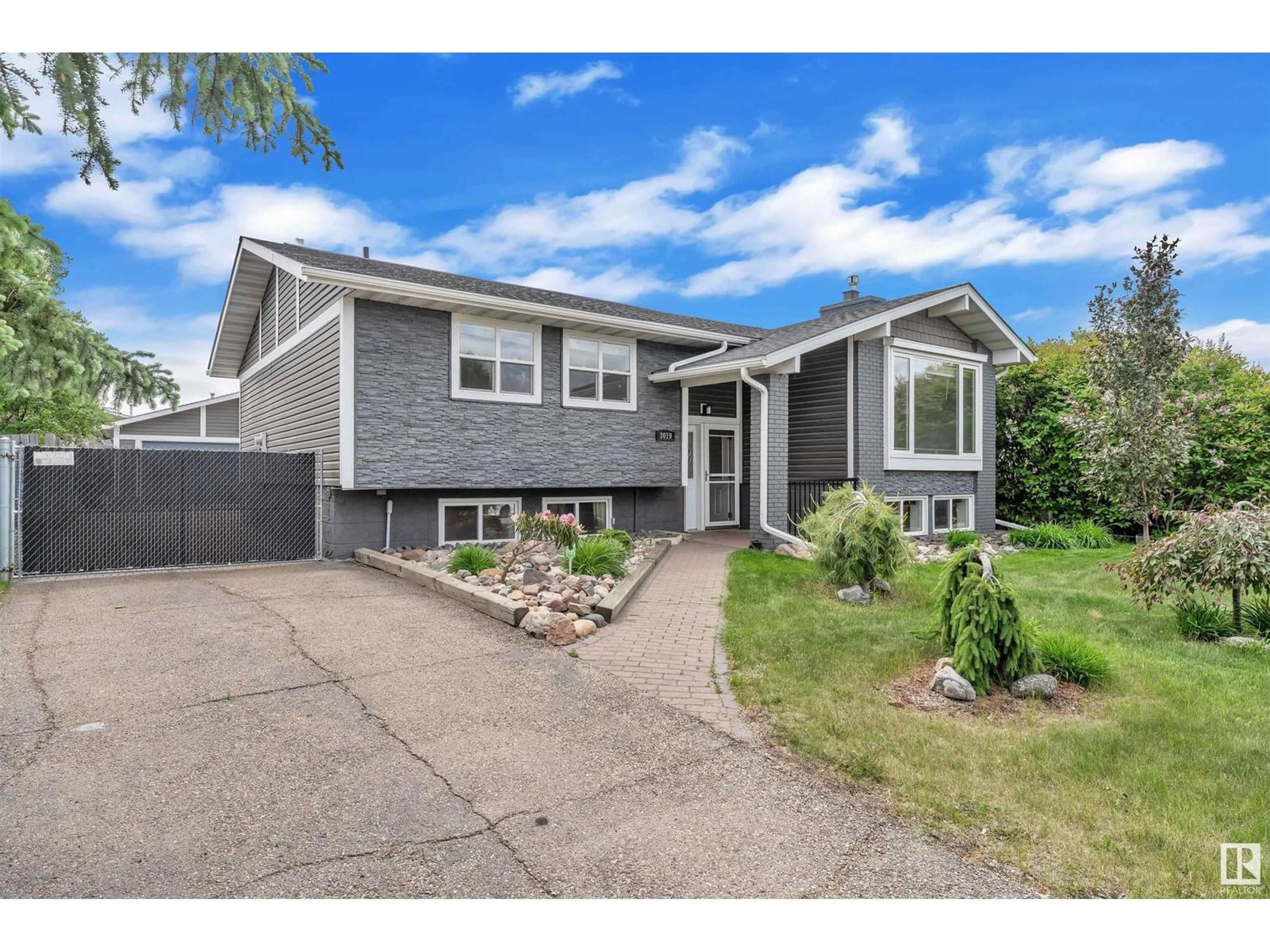Home with vinyl exterior material, street for NW - 3019 133 AV, Edmonton Alberta T5A2Z4