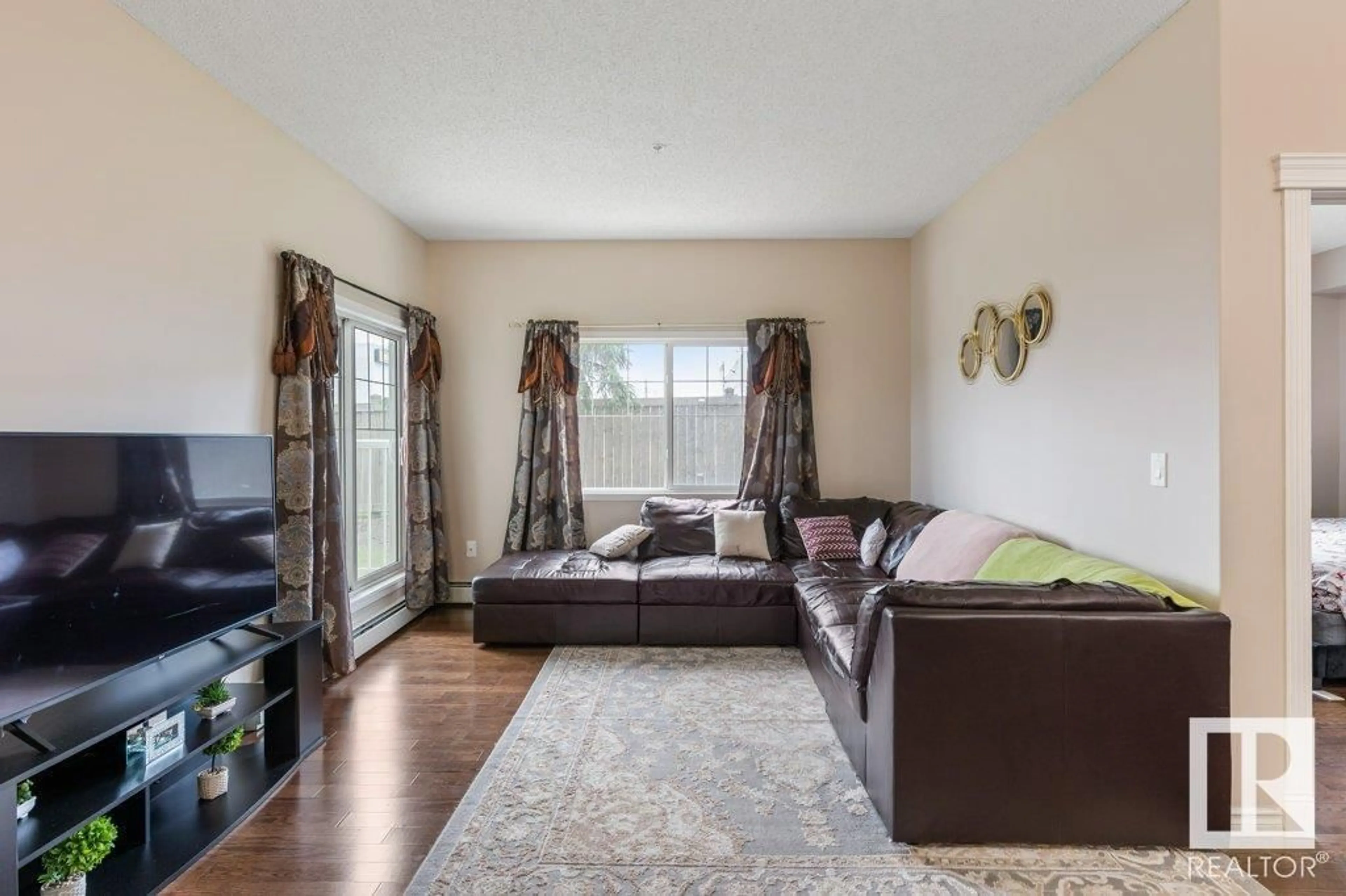 Living room with furniture, wood/laminate floor for #135 - 16807 100 AV, Edmonton Alberta T5P4Z6