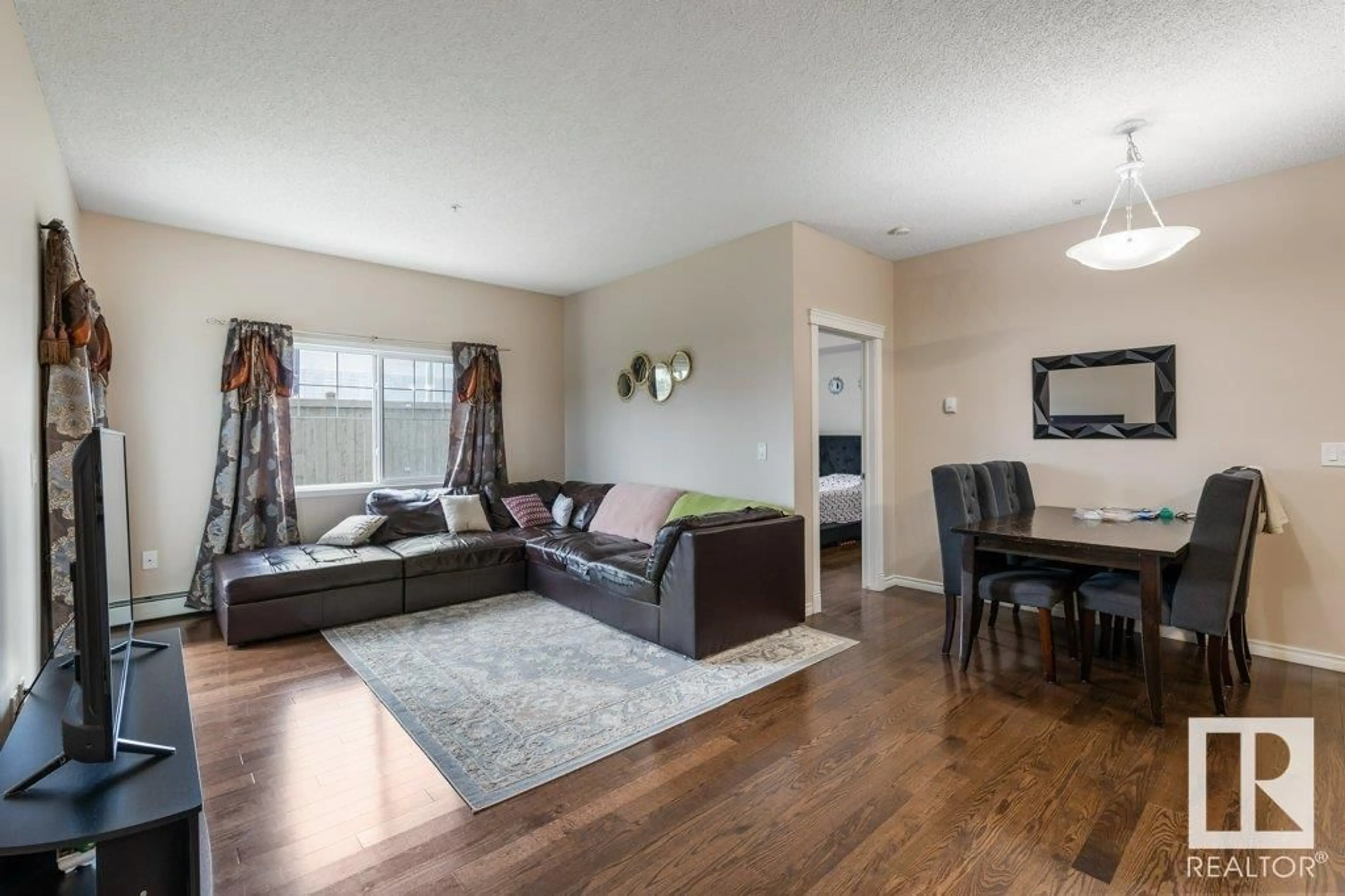 Living room with furniture, wood/laminate floor for #135 - 16807 100 AV, Edmonton Alberta T5P4Z6