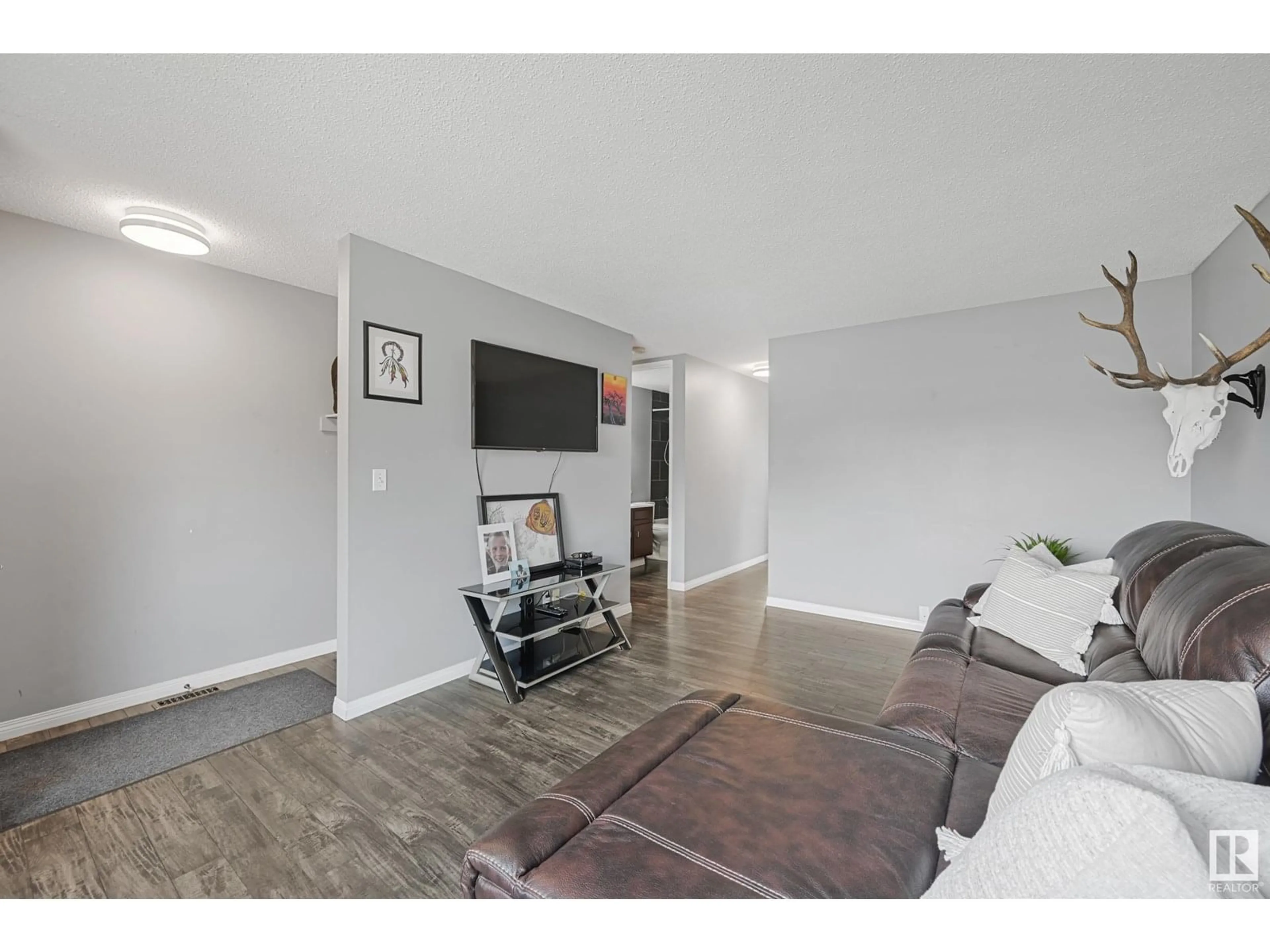 Living room with furniture, wood/laminate floor for 9202 79 ST, Fort Saskatchewan Alberta T8L3L7